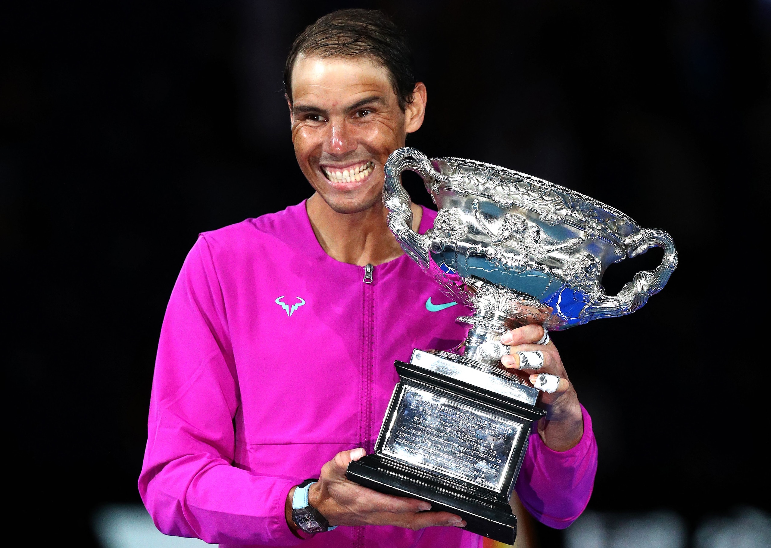 Spain's Rafael Nadal smile as he holds the Norman Brookes Challenge Cup trophy following his victory against Russia's Daniil Medvedev in their men's singles final match on day fourteen of the Australian Open tennis tournament in Melbourne on January 31, 2022. - -- IMAGE RESTRICTED TO EDITORIAL USE - STRICTLY NO COMMERCIAL USE -- (Photo by Aaron FRANCIS / AFP) / -- IMAGE RESTRICTED TO EDITORIAL USE - STRICTLY NO COMMERCIAL USE -- (Photo by AARON FRANCIS/AFP via Getty Images)