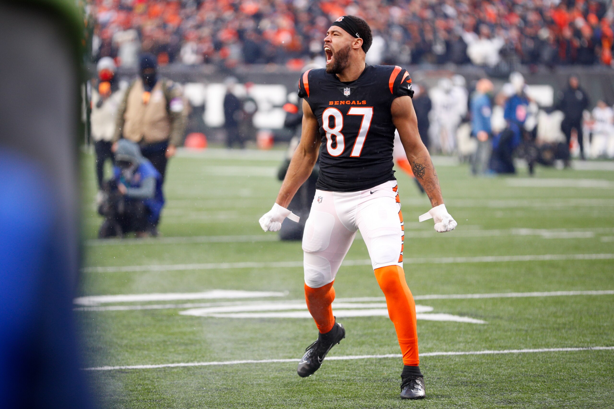CINCINNATI, OH - JANUARY 15: Cincinnati Bengals tight end C.J. Uzomah (87) runs onto the field before the Wild Card game against the Las Vegas Raiders and the Cincinnati Bengals on January 15, 2022, at Paul Brown Stadium in Cincinnati, OH. (Photo by Ian Johnson/Icon Sportswire via Getty Images)