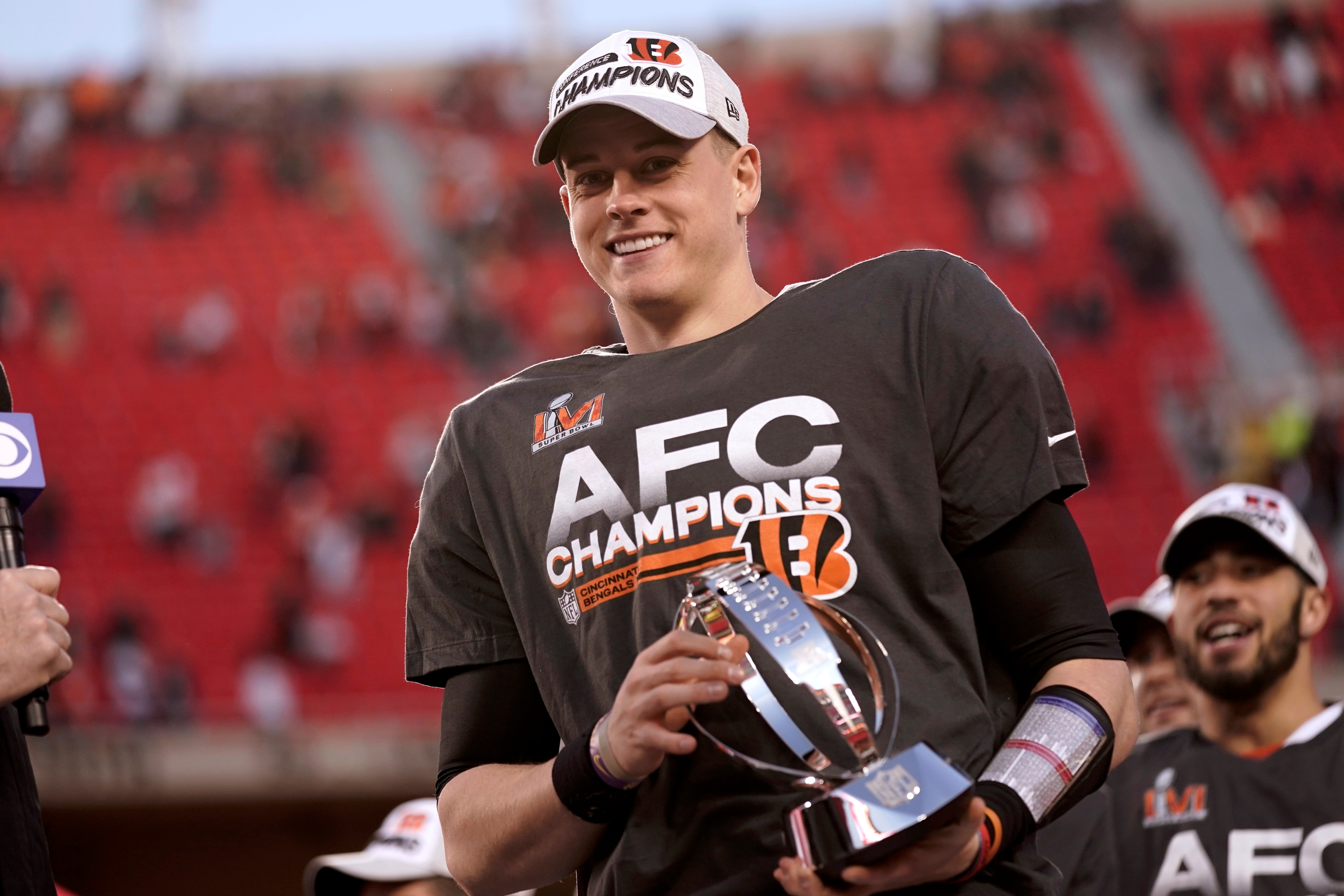 Cincinnati Bengals quarterback Joe Burrow (9) holds the Lamar Hunt trophy after an AFC championship NFL football game against the Kansas City Chiefs, Sunday, Jan. 30, 2022, in Kansas City, Mo. The Bengals won 27-24 in overtime. (AP Photo/Charlie Riedel)