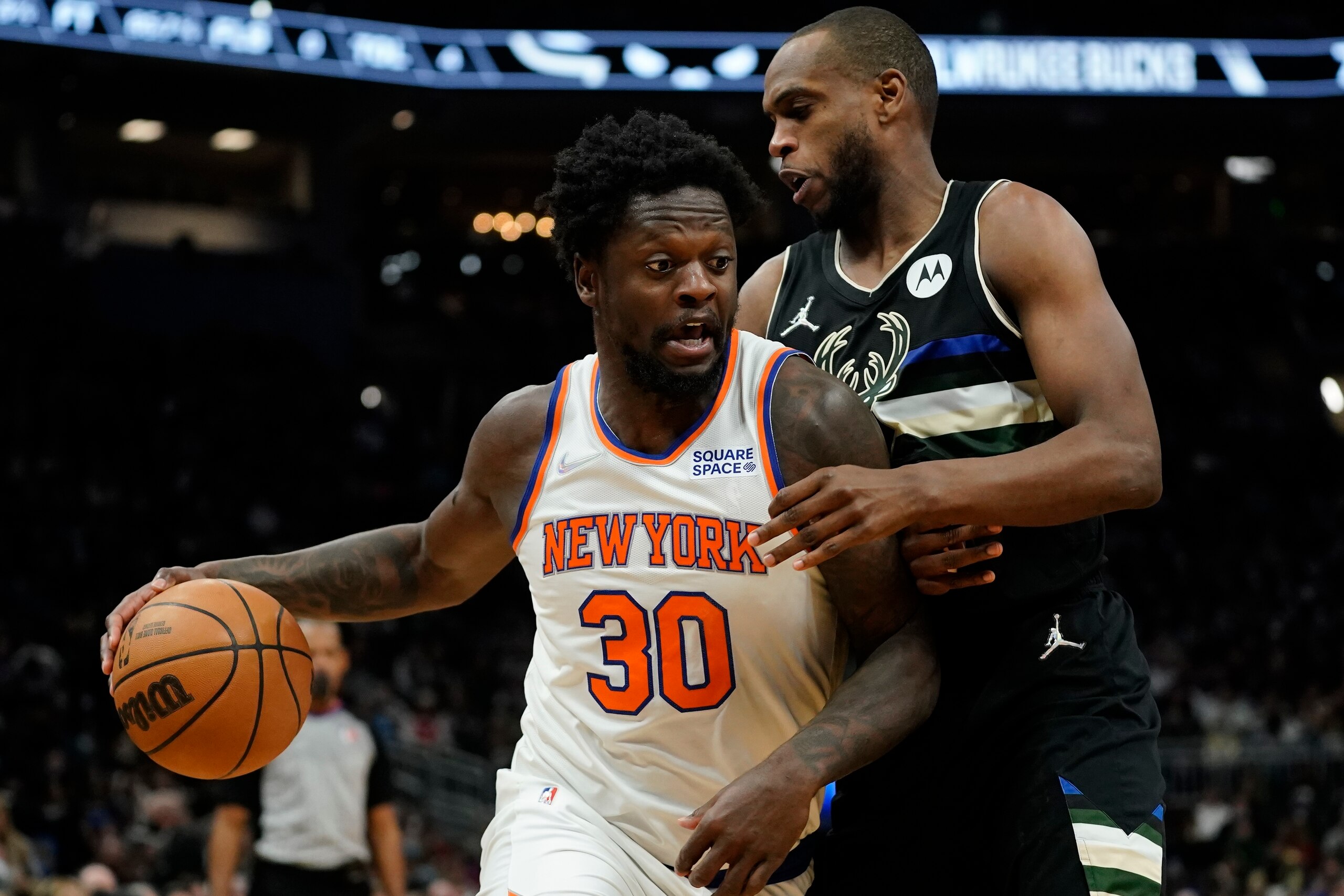 New York Knicks' Julius Randle drives past Milwaukee Bucks' Khris Middleton during the second half of an NBA basketball game Friday, Jan. 28, 2022, in Milwaukee. The Bucks won 123-108. (AP Photo/Morry Gash)