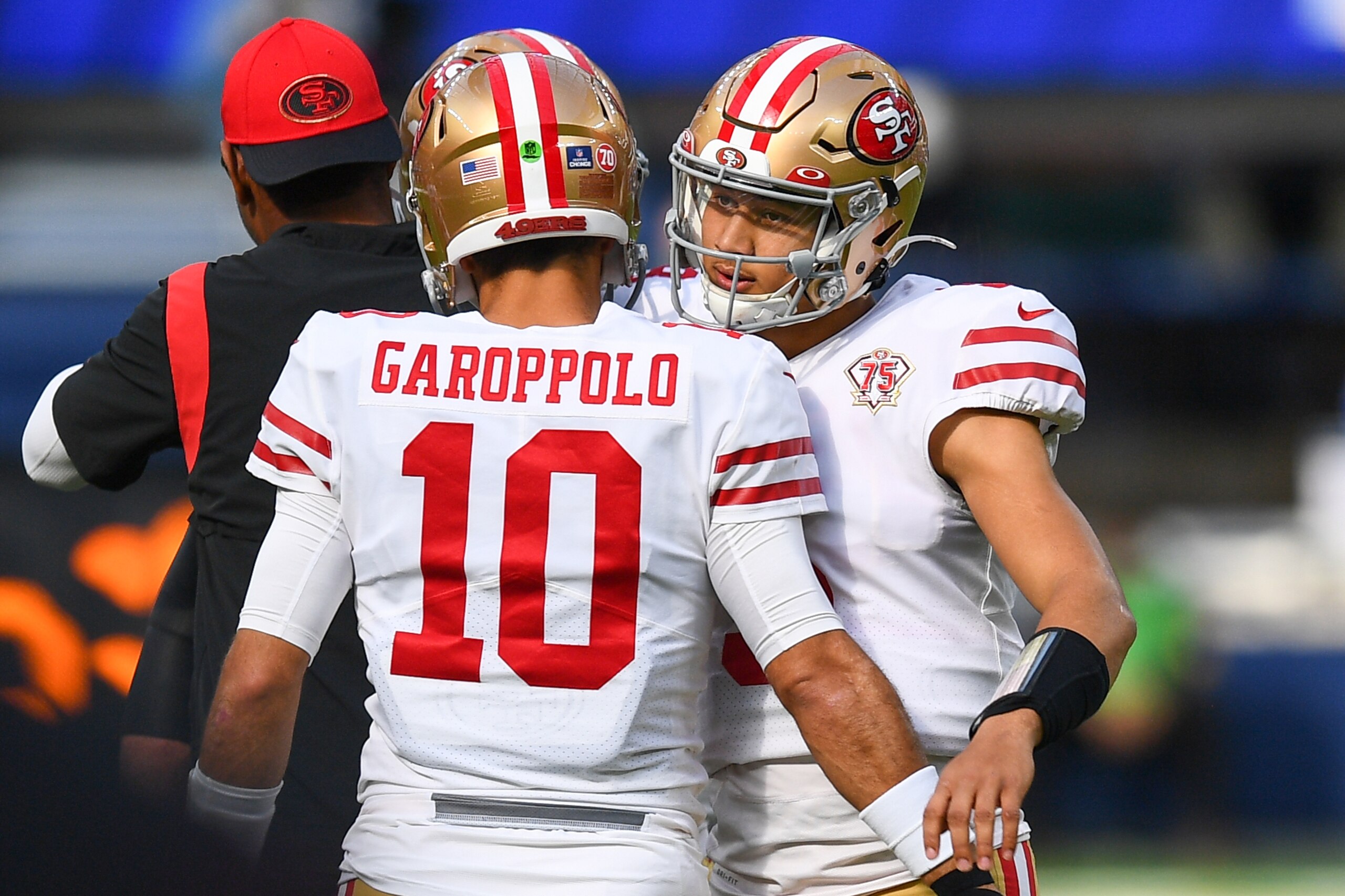 INGLEWOOD, CA - JANUARY 09: San Francisco 49ers Quarterback Jimmy Garoppolo (10) hugs San Francisco 49ers Quarterback Trey Lance (5) before the NFL game between the San Francisco 49ers and the Los Angeles Rams on January 9, 2022, at SoFi Stadium in Inglewood, CA. (Photo by Brian Rothmuller/Icon Sportswire via Getty Images)