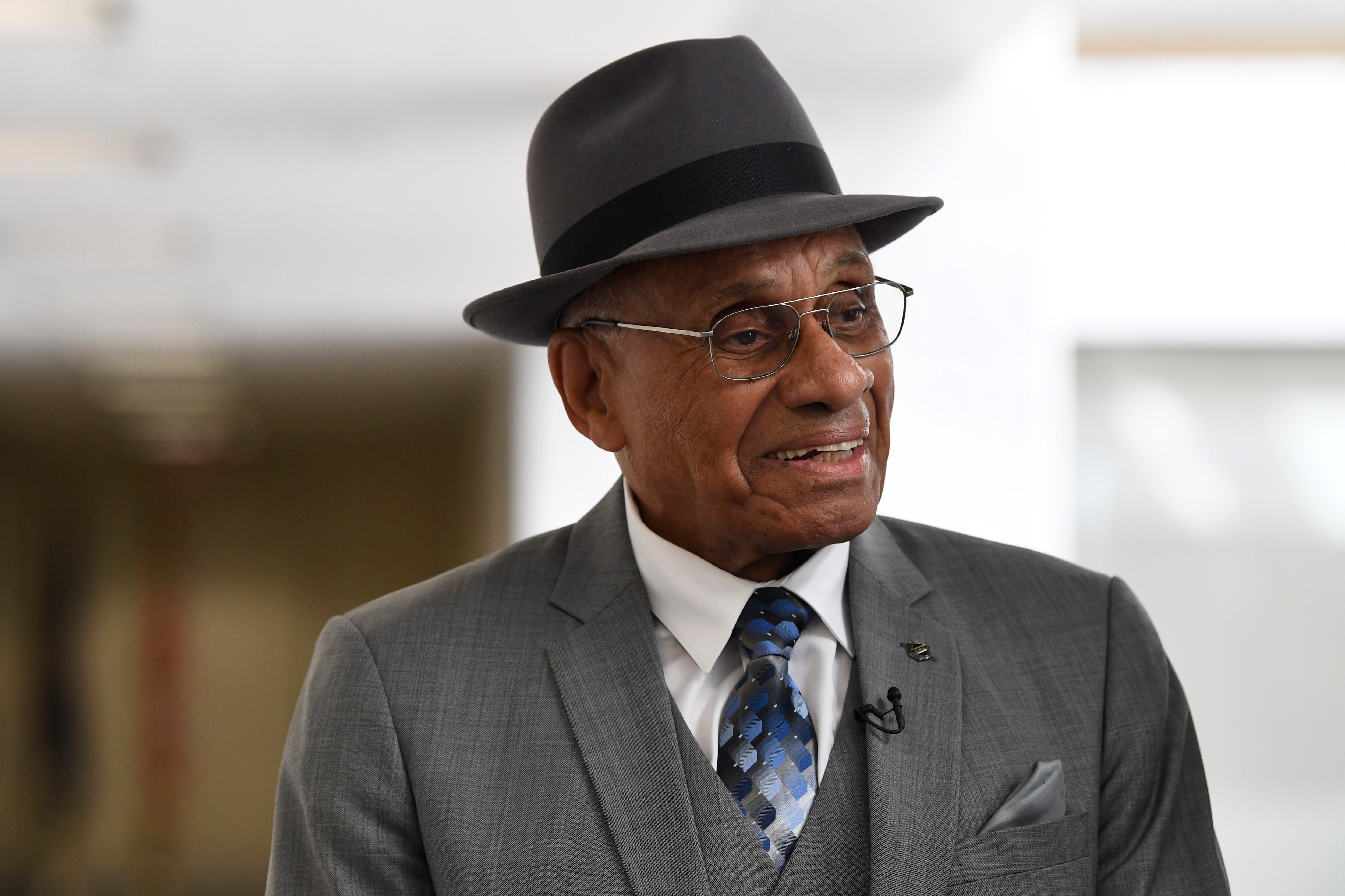 FILE - Willie O'Ree arrives for a meeting on Capitol Hill in Washington, July 25, 2019. O'Ree says the ongoing pandemic hasn't diminished what he says will be a "simply amazing" honor watching his No. 22 jersey retired by the Bruins. O'Ree, who became the first Black NHL player on Jan. 18, 1958, was slated to attend when he became the 12th player in team history to have his number retired prior to Boston's game against Carolina on Tuesday, Jan. 18, 2022. But persisting concerns about the pandemic changed those plans. He will now participate from his home in San Diego. (AP Photo/Susan Walsh, File)