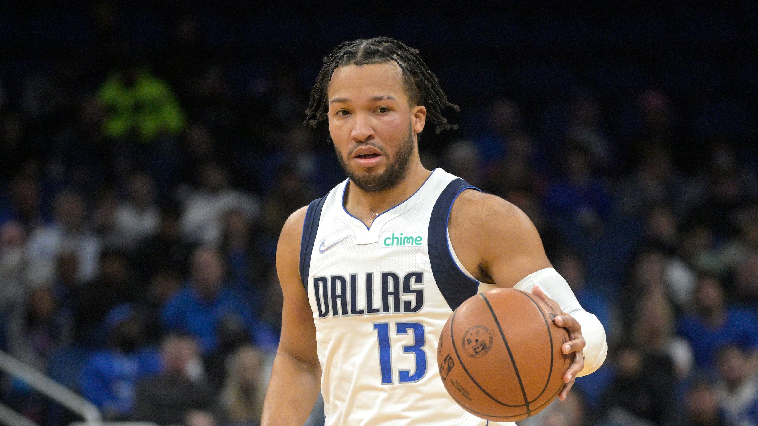 Dallas Mavericks guard Jalen Brunson (13) sets up a play during the first half of an NBA basketball game against the Orlando Magic, Sunday, Jan. 30, 2022, in Orlando, Fla. (AP Photo/Phelan M. Ebenhack)