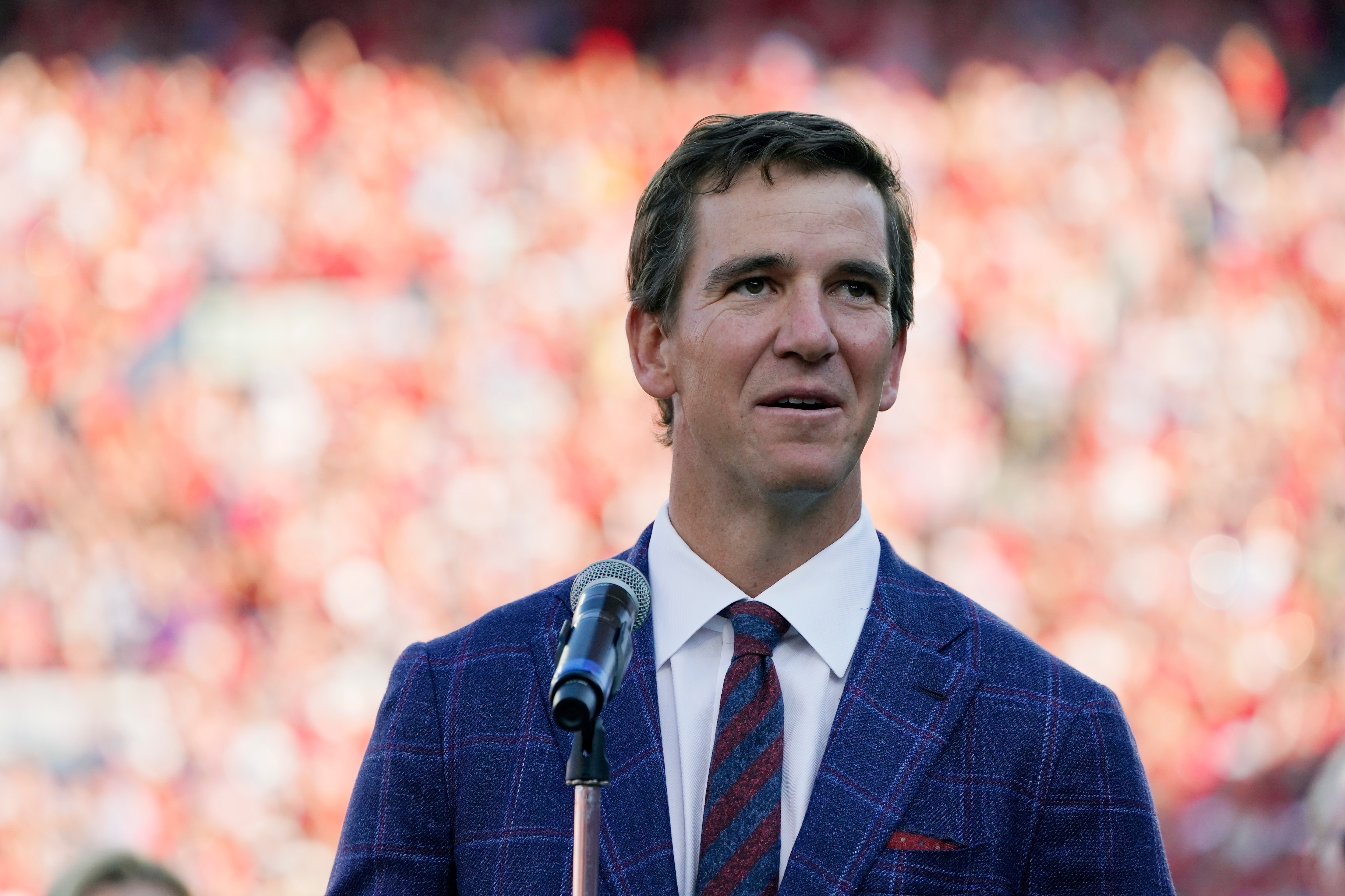 Former Mississippi quarterback Eli Manning addresses the crowd as his jersey, number 10, is retired at a half time ceremony during an NCAA college football game against LSU in Oxford, Miss., Saturday, Oct. 23, 2021. Mississippi won 31-17. (AP Photo/Rogelio V. Solis)
