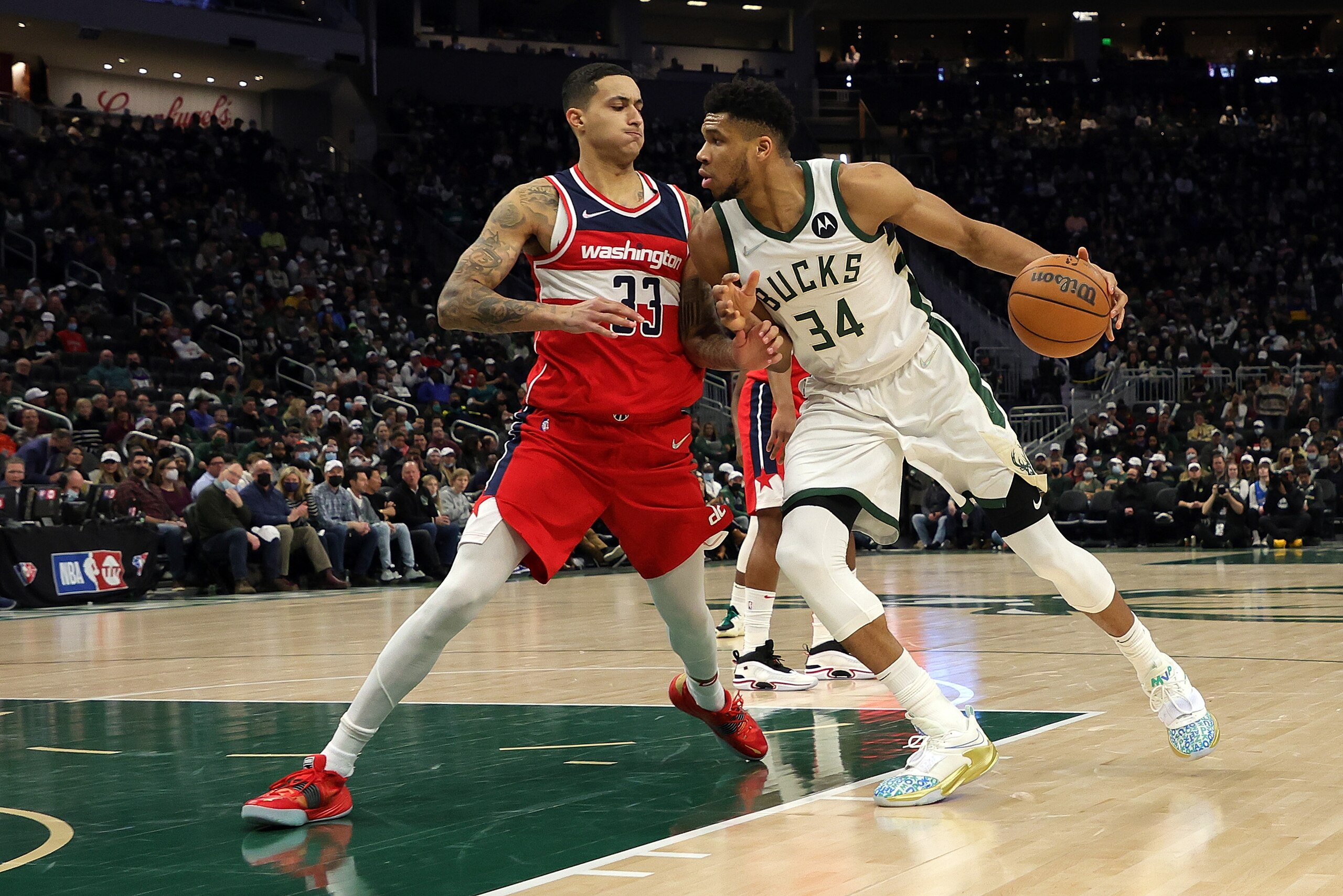 MILWAUKEE, WISCONSIN - FEBRUARY 01: Giannis Antetokounmpo #34 of the Milwaukee Bucks is defended by Kyle Kuzma #33 of the Washington Wizards during the first half of a game at Fiserv Forum on February 01, 2022 in Milwaukee, Wisconsin. NOTE TO USER: User expressly acknowledges and agrees that, by downloading and or using this photograph, User is consenting to the terms and conditions of the Getty Images License Agreement. (Photo by Stacy Revere/Getty Images)