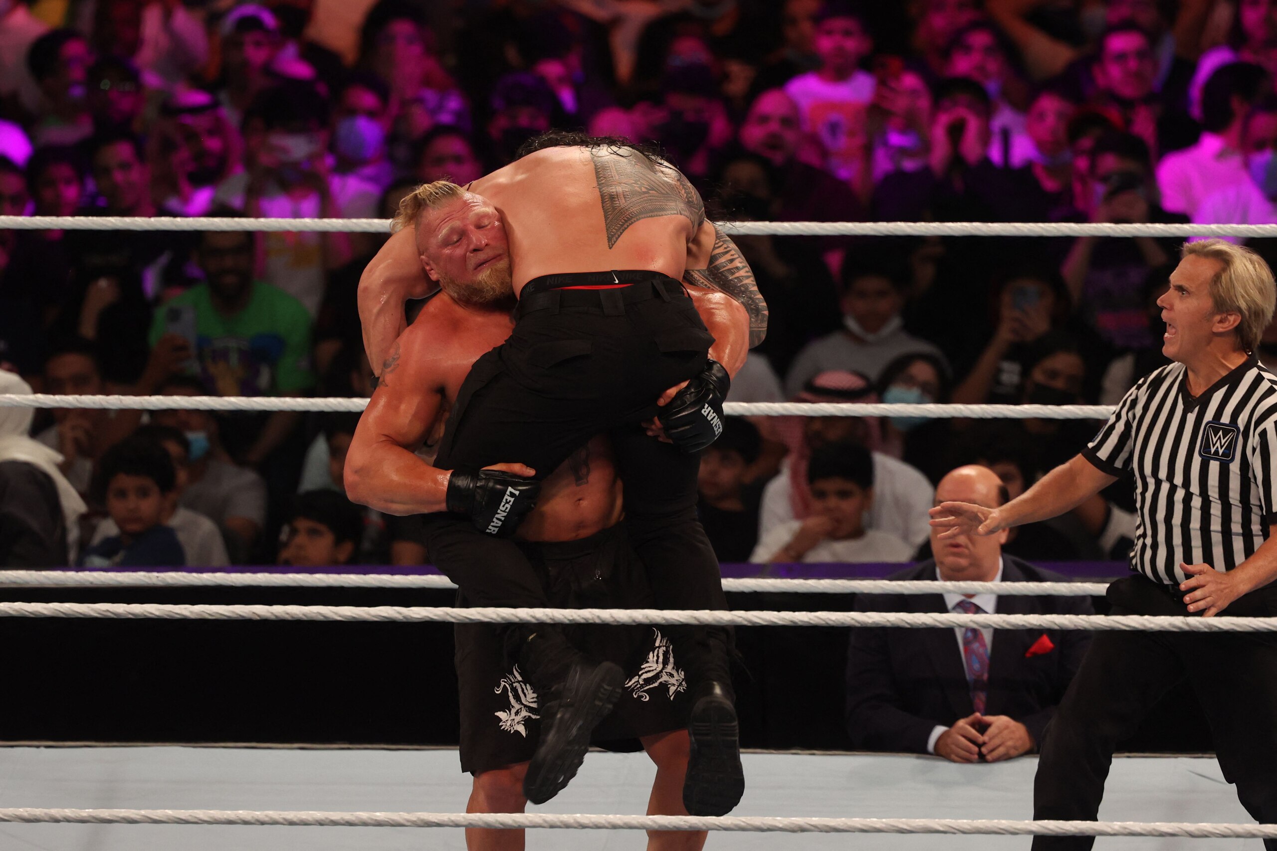Roman Reigns (R) competes with Brock Lesnar during the World Wrestling Entertainment (WWE) Crown Jewel pay-per-view in the Saudi capital Riyadh on October 21, 2021. (Photo by Fayez Nureldine / AFP) (Photo by FAYEZ NURELDINE/AFP via Getty Images)