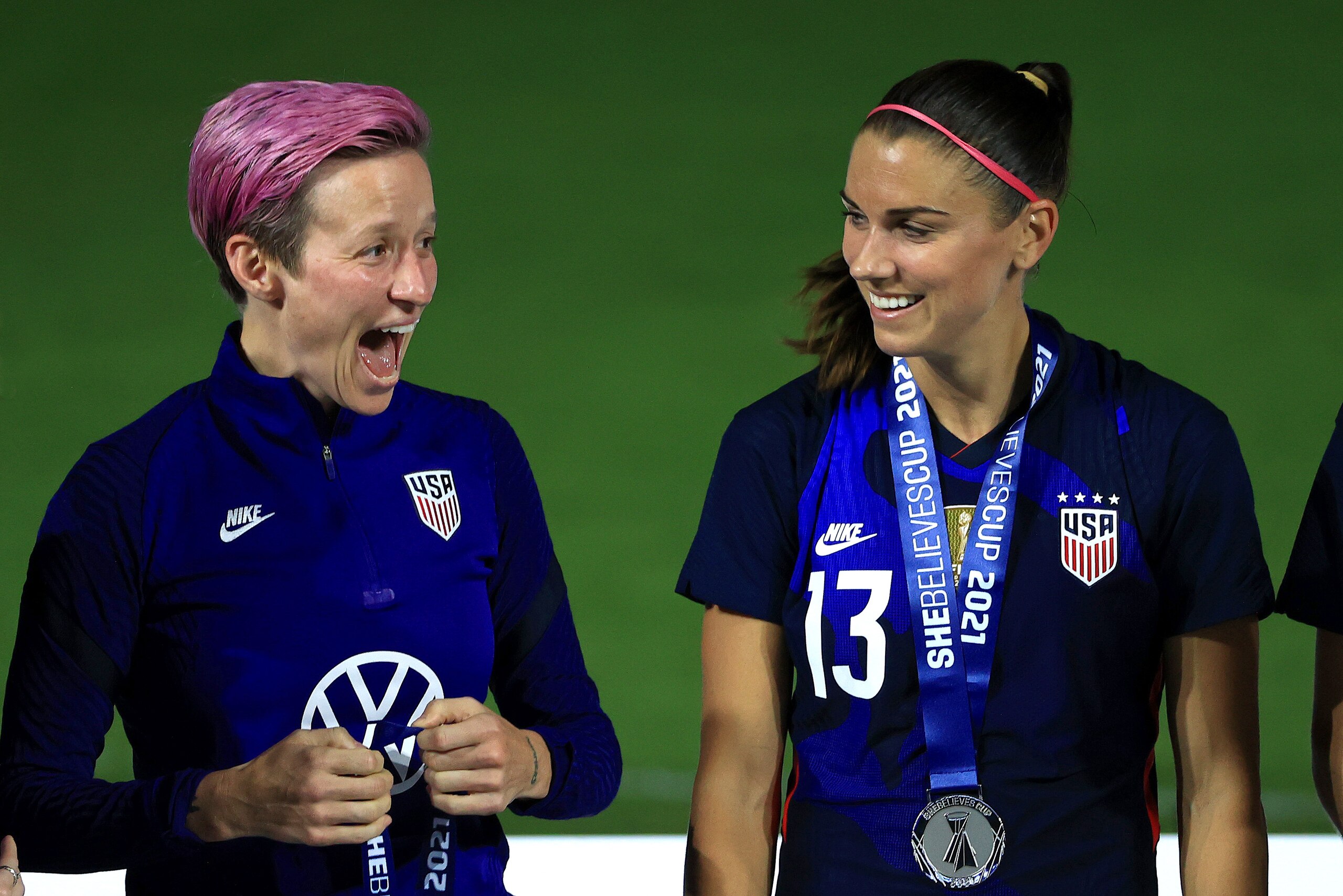 ORLANDO, FLORIDA - FEBRUARY 24: Megan Rapinoe #15 and Alex Morgan #13 of the United States  celebrate winning the SheBelieves Cup at Exploria Stadium on February 24, 2021 in Orlando, Florida. (Photo by Mike Ehrmann/Getty Images)