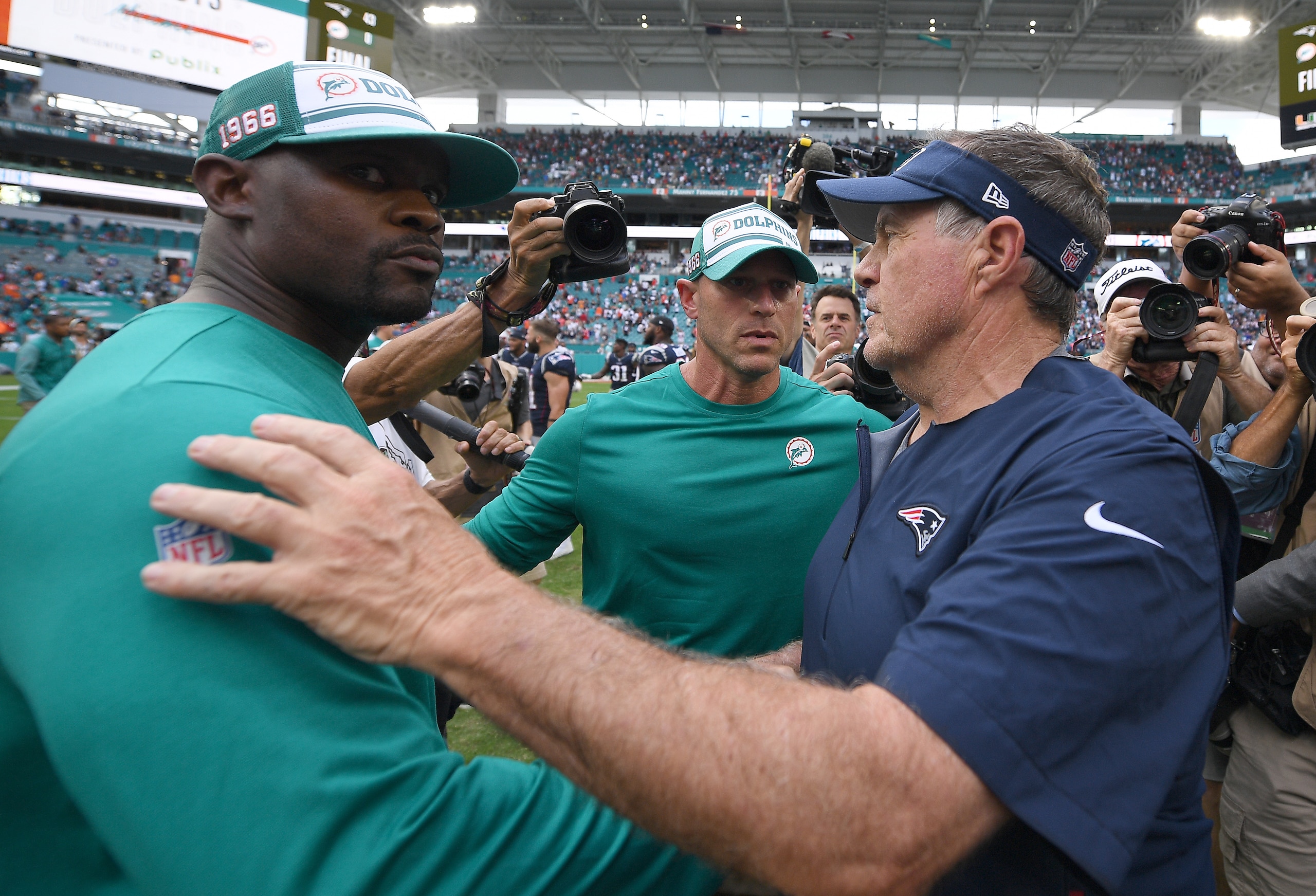 MIAMI, FLORIDA - SEPTEMBER 15: Head coach Brian Flores of the Miami Dolphins and Head coach Bill Belichick of the New England Patriots 
 shake hands after the game at Hard Rock Stadium on September 15, 2019 in Miami, Florida. (Photo by Mark Brown/Getty Images)