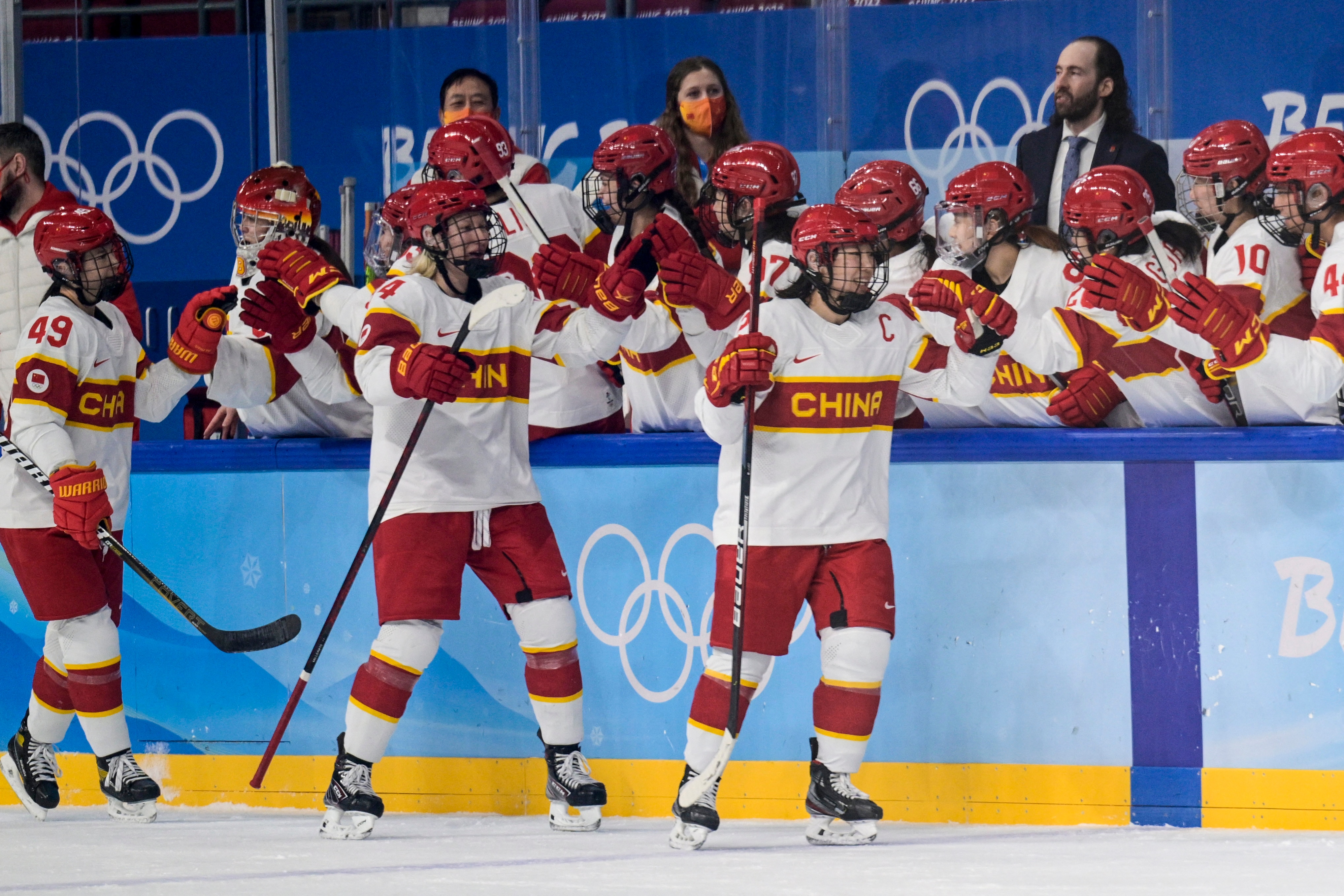 China's players celebrate victory during the women's preliminary round group B match of the Beijing 2022 Winter Olympic Games ice hockey competition between Denmark and China, at the Wukesong Sports Centre in Beijing on February 4, 2022. (Photo by Sebastien Bozon / AFP) (Photo by SEBASTIEN BOZON/AFP via Getty Images)