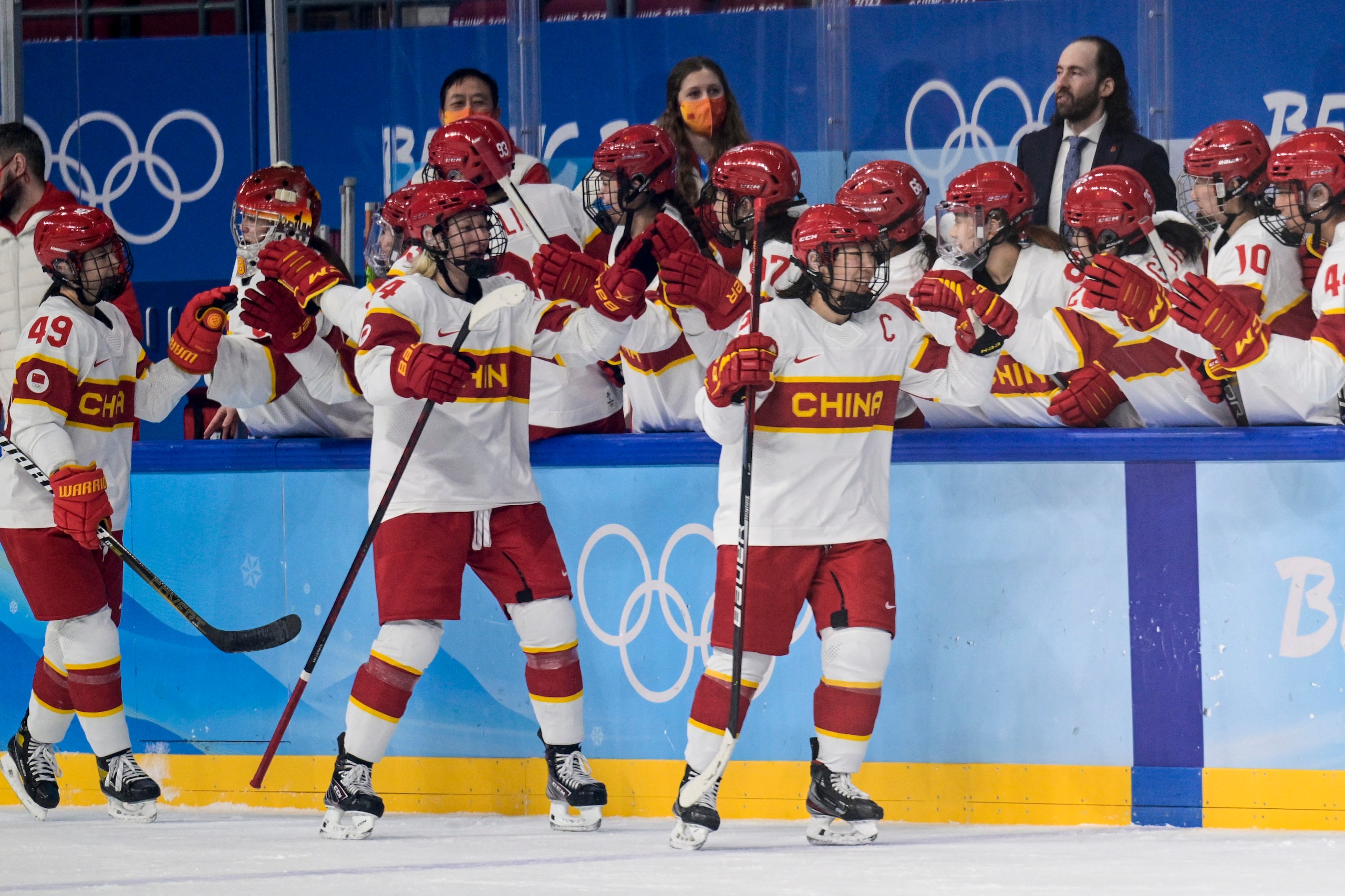 China's players celebrate victory during the women's preliminary round group B match of the Beijing 2022 Winter Olympic Games ice hockey competition between Denmark and China, at the Wukesong Sports Centre in Beijing on February 4, 2022. (Photo by Sebastien Bozon / AFP) (Photo by SEBASTIEN BOZON/AFP via Getty Images)