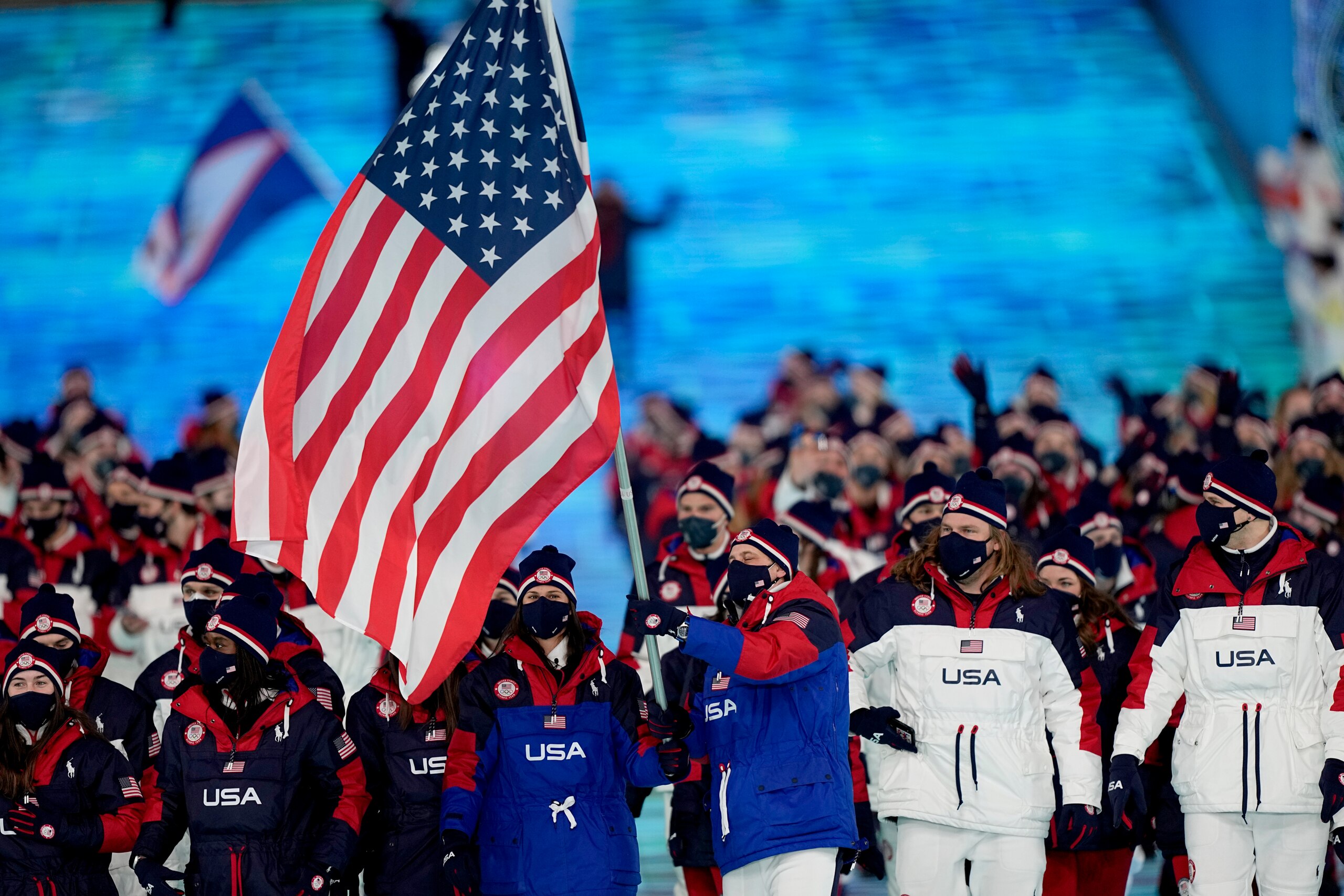 Brittany Bowe and John Shuster, of the United States, lead their team in during the opening ceremony of the 2022 Winter Olympics, Friday, Feb. 4, 2022, in Beijing. (AP Photo/David J. Phillip)