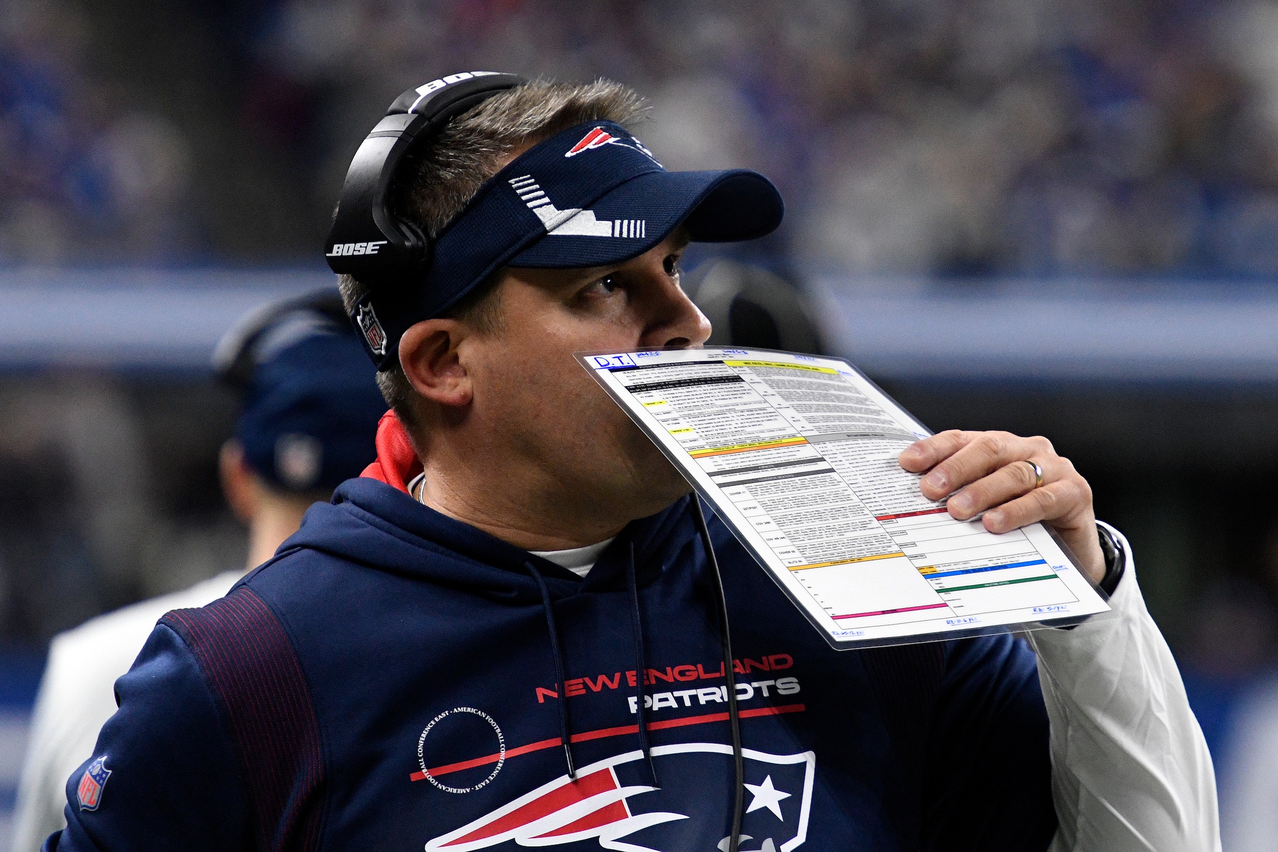 INDIANAPOLIS, IN - DECEMBER 18: New England Patriots offensive coordinator Josh McDaniels covers his mouth as he talks on his headset during the NFL football game between the New England Patriots and the Indianapolis Colts on December 18, 2021, at Lucas Oil Stadium in Indianapolis, Indiana. (Photo by Michael Allio/Icon Sportswire via Getty Images)