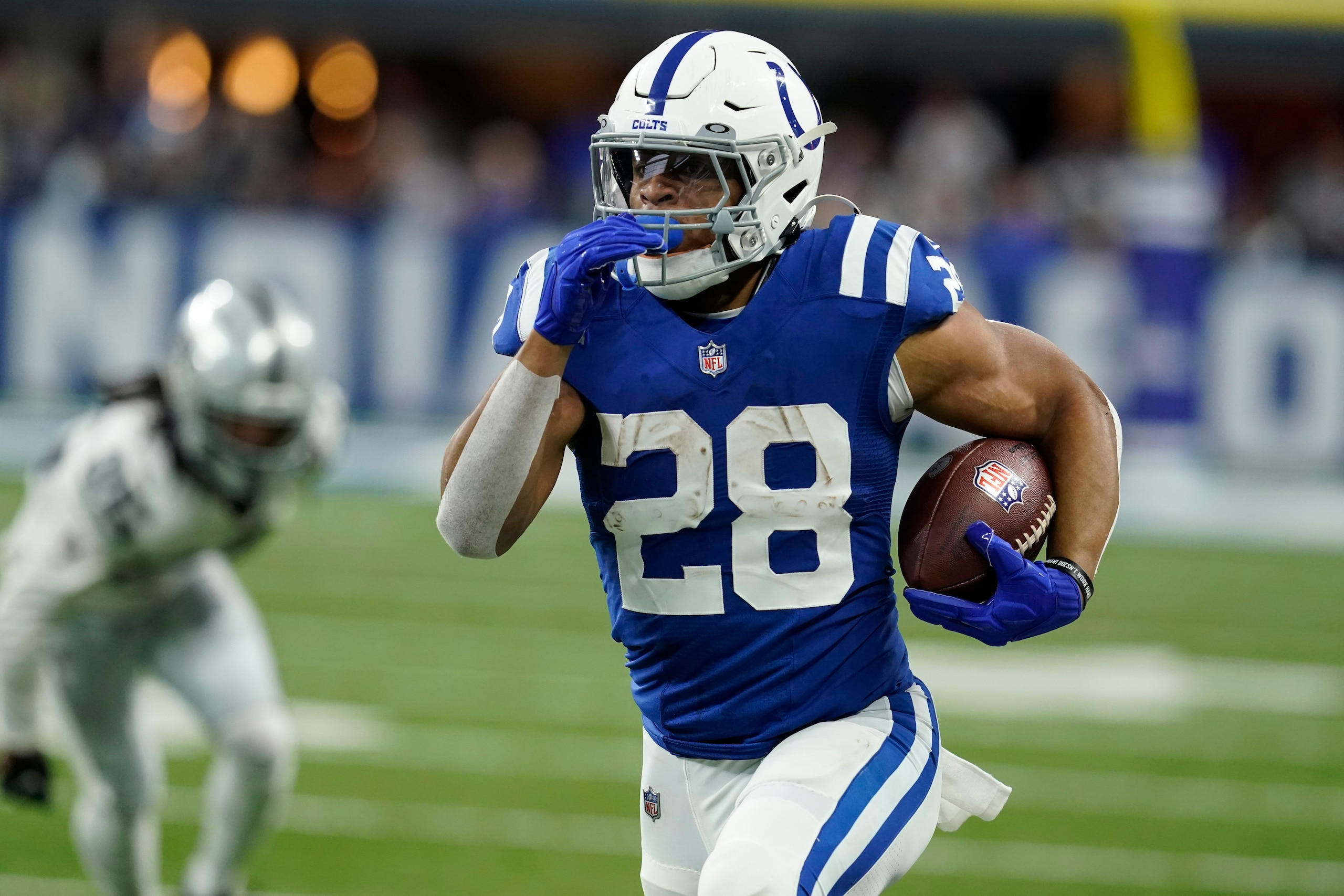 Indianapolis Colts running back Jonathan Taylor (28) carries the ball up field during the first half of an NFL football game against the Las Vegas Raiders, Sunday, Jan. 2, 2022, in Indianapolis. (AP Photo/Darron Cummings)