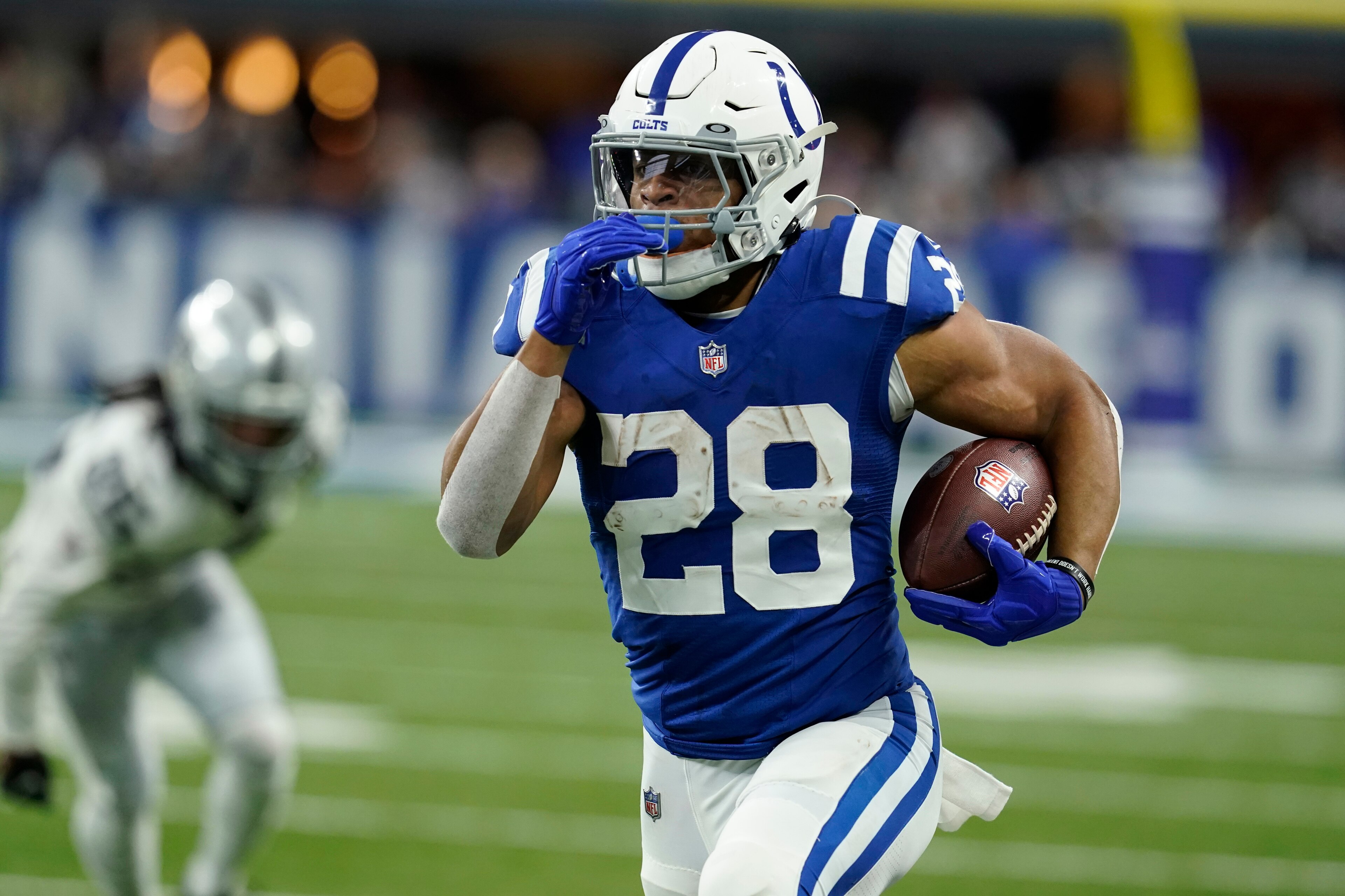 Indianapolis Colts running back Jonathan Taylor (28) carries the ball up field during the first half of an NFL football game against the Las Vegas Raiders, Sunday, Jan. 2, 2022, in Indianapolis. (AP Photo/Darron Cummings)