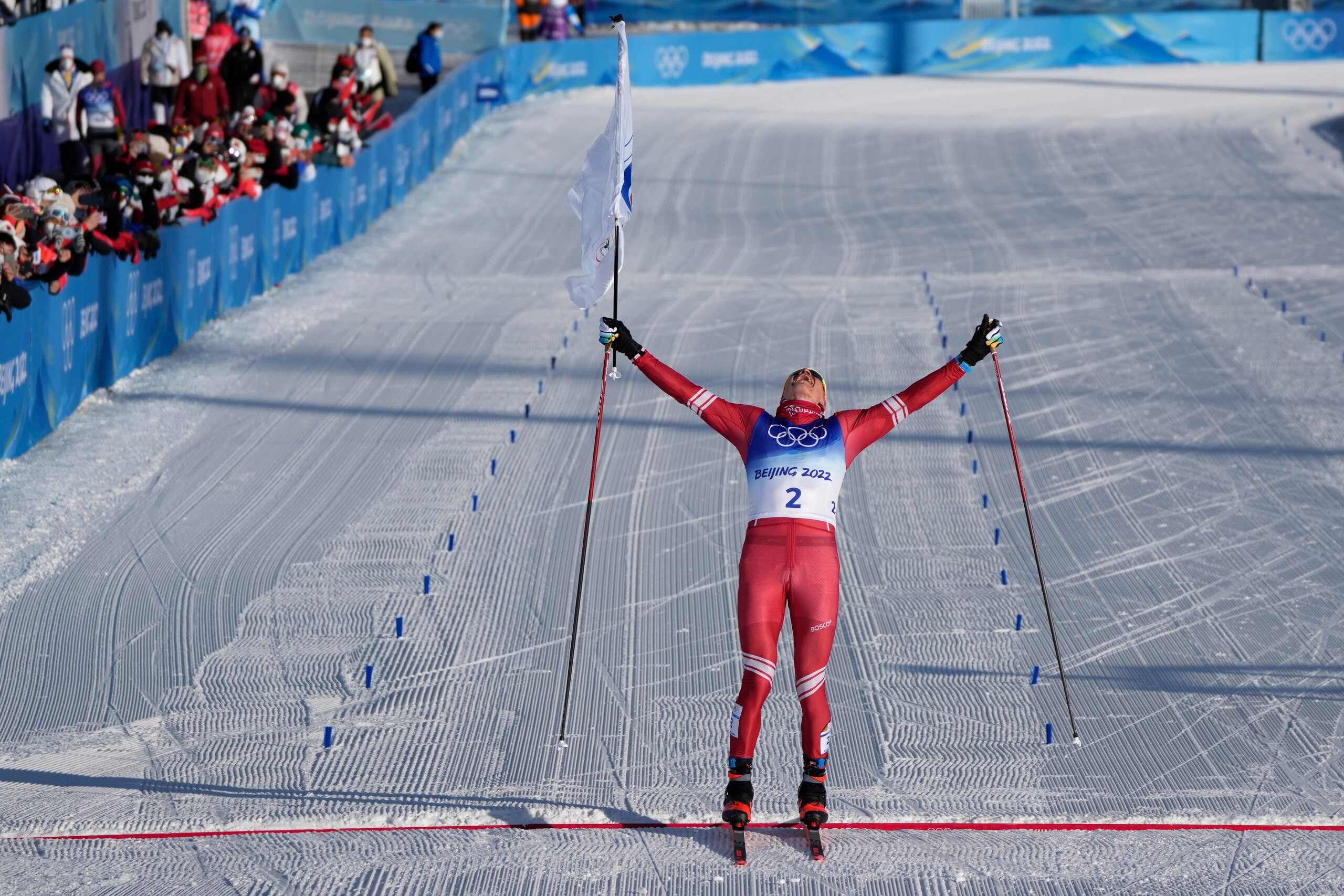 Russian athlete Alexander Bolshunov celebrates winning the gold medal during the men's 15km + 15km skiathlon cross-country skiing competition at the 2022 Winter Olympics, Sunday, Feb. 6, 2022, in Zhangjiakou, China. (AP Photo/Alessandra Tarantino)