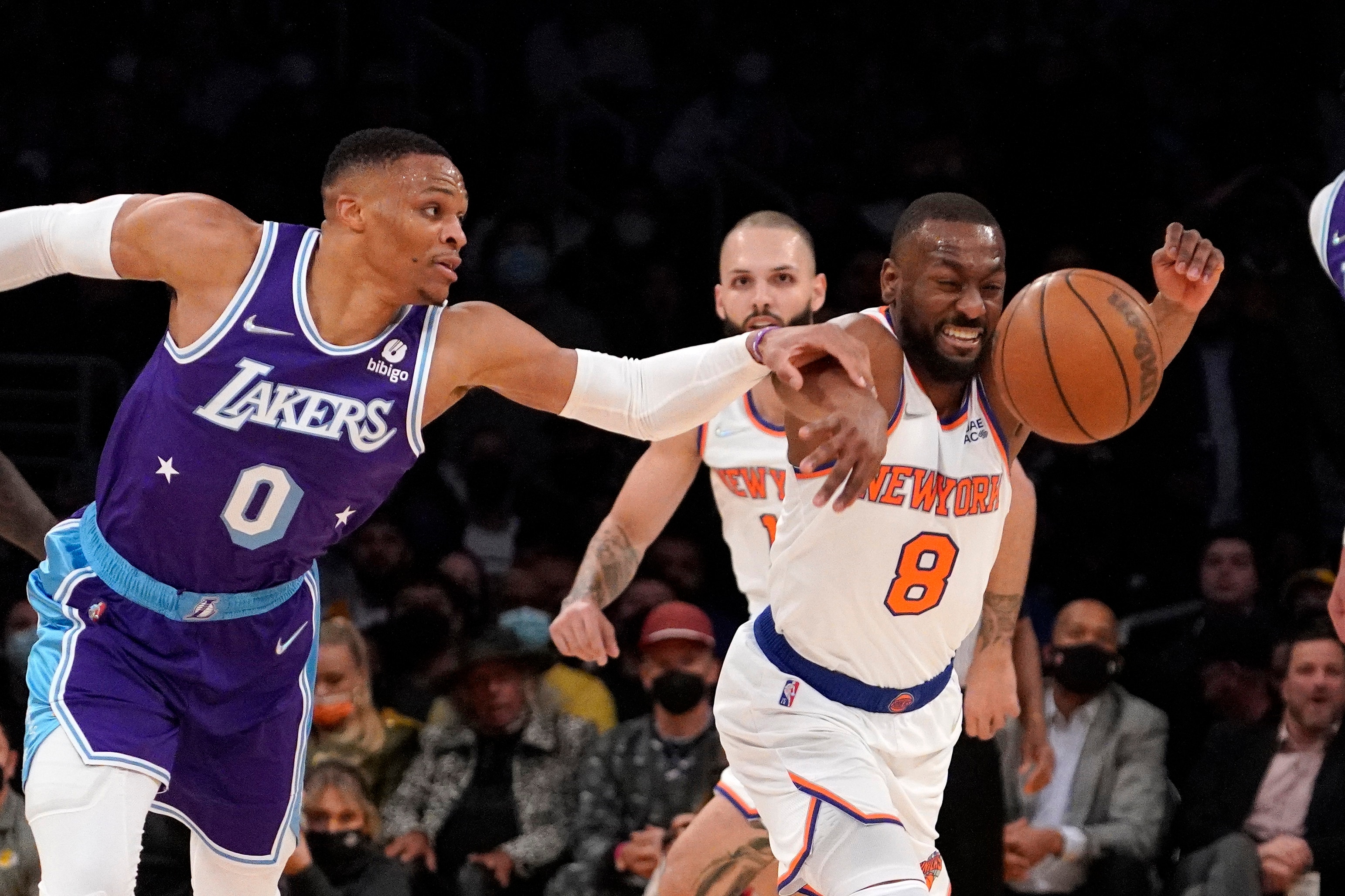 Los Angeles Lakers guard Russell Westbrook, left, and New York Knicks guard Kemba Walker reach for a loose ball during the second half of an NBA basketball game Saturday, Feb. 5, 2022, in Los Angeles. The Lakers won 122-115 in overtime. (AP Photo/Mark J. Terrill)