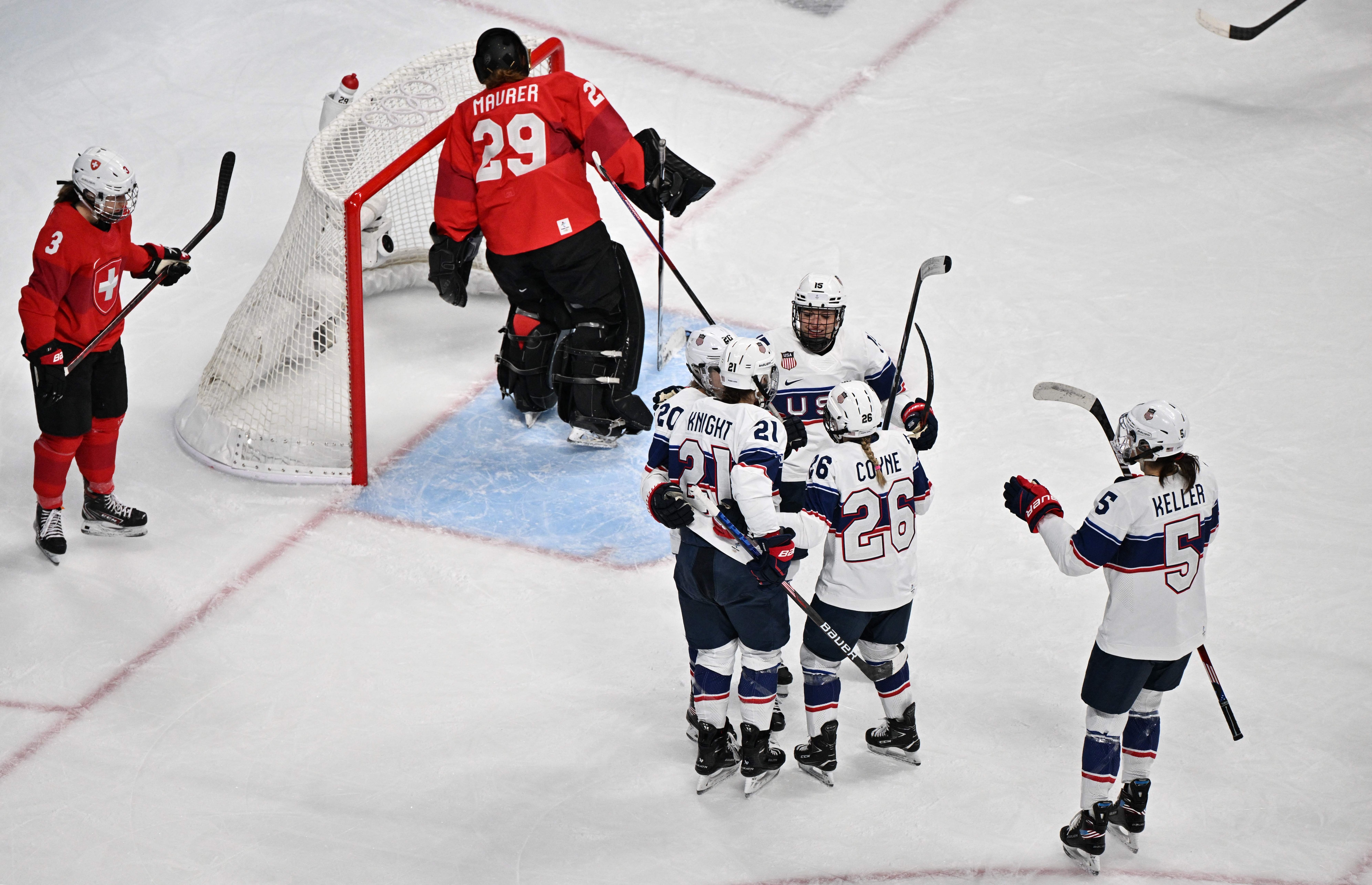 USA's Hilary Knight (L) celebrates with teammates after scoring a goal against Switzerland during the women's preliminary round group A match of the Beijing 2022 Winter Olympic Games ice hockey competition, at the Wukesong Sports Centre in Beijing on February 6, 2022. (Photo by ANTHONY WALLACE / AFP) (Photo by ANTHONY WALLACE/AFP via Getty Images)