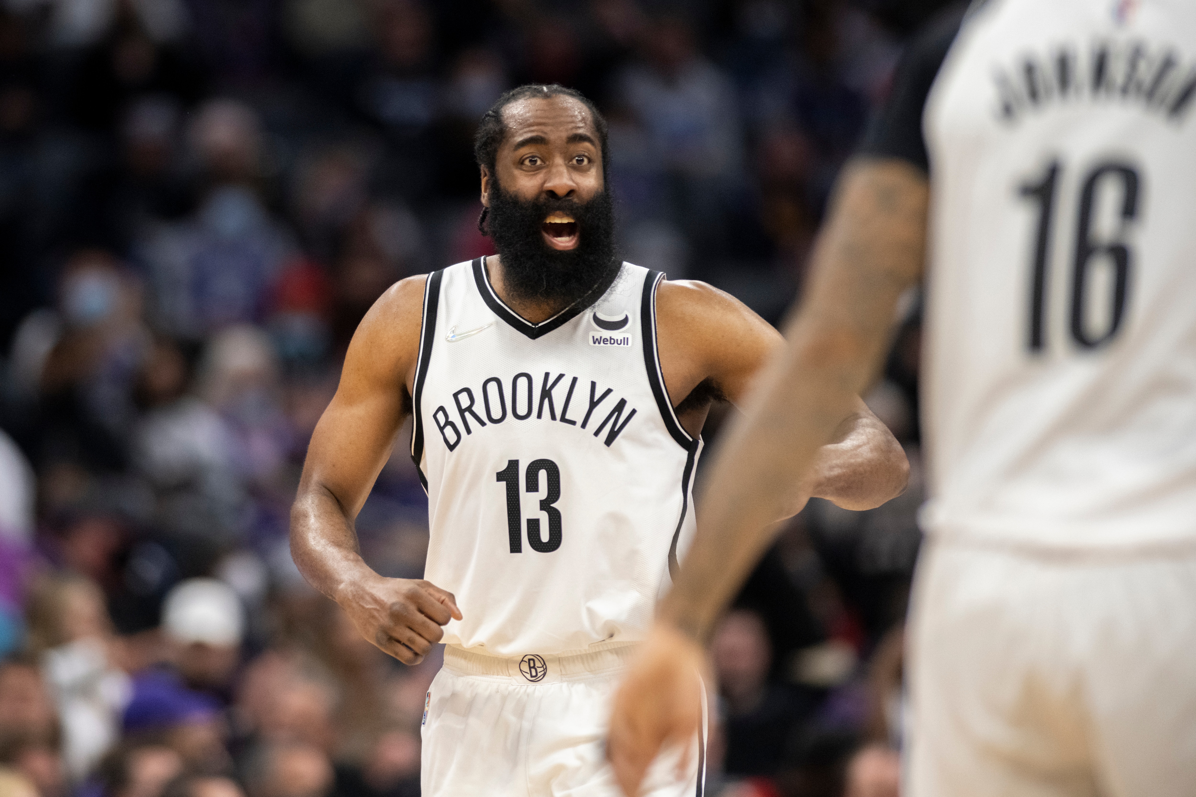 Brooklyn Nets guard James Harden (13) yells to forward James Johnson (16) during the second half of the team's NBA basketball game against the Sacramento Kings in Sacramento, Calif., Wednesday, Feb. 2, 2022. (AP Photo/José Luis Villegas)