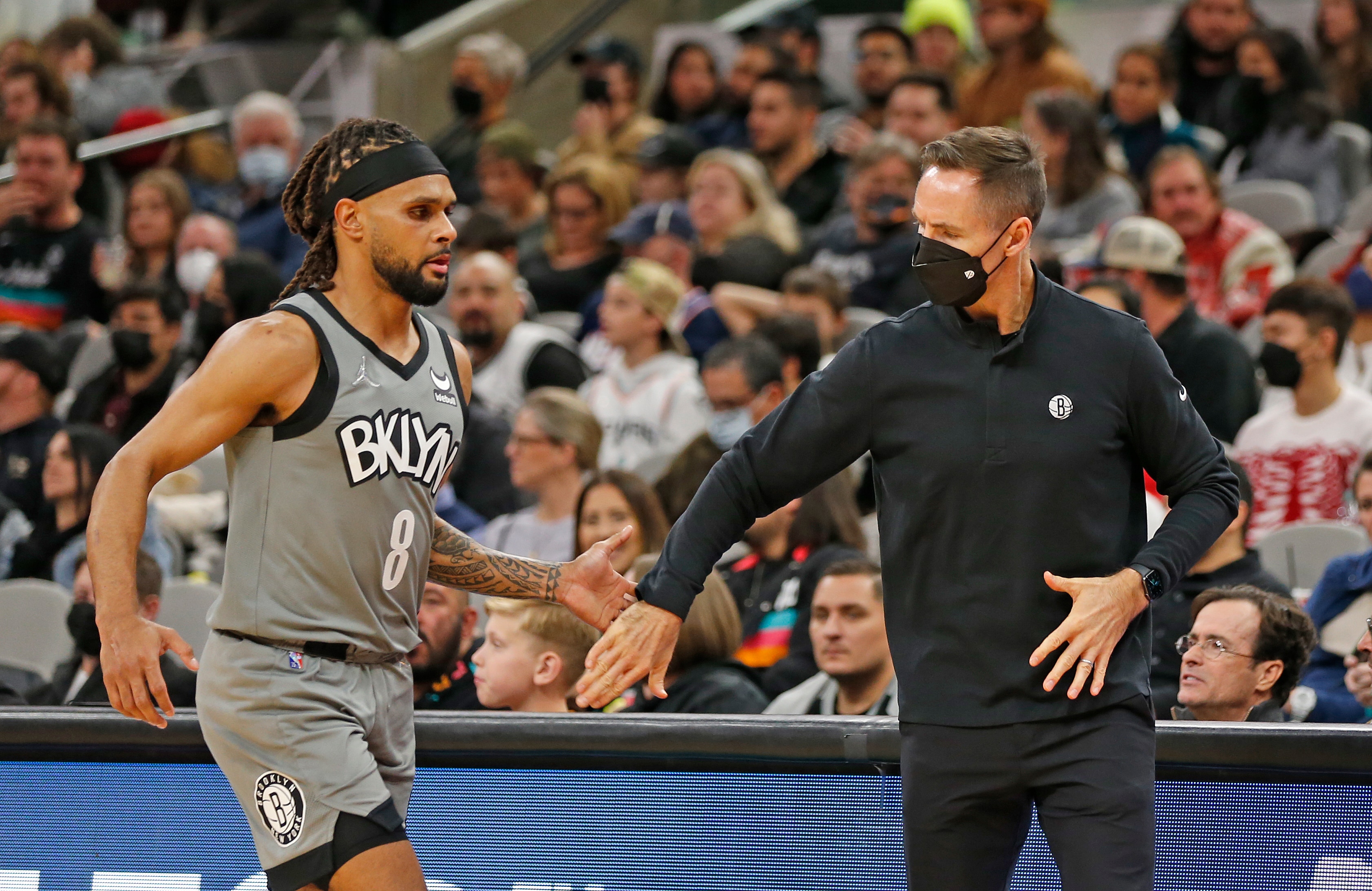 SAN ANTONIO, TX - JANUARY 21: Steve Nash Head coach of the Brooklyn Nets greets Patty Mills #8 of the Brooklyn Nets as he comes to the bench during game against the San Antonio Spurs in the first half at AT&T Center on January 21, 2022 in San Antonio, Texas. NOTE TO USER: User expressly acknowledges and agrees that, by downloading and or using this photograph, User is consenting to terms and conditions of the Getty Images License Agreement. (Photo by Ronald Cortes/Getty Images)
