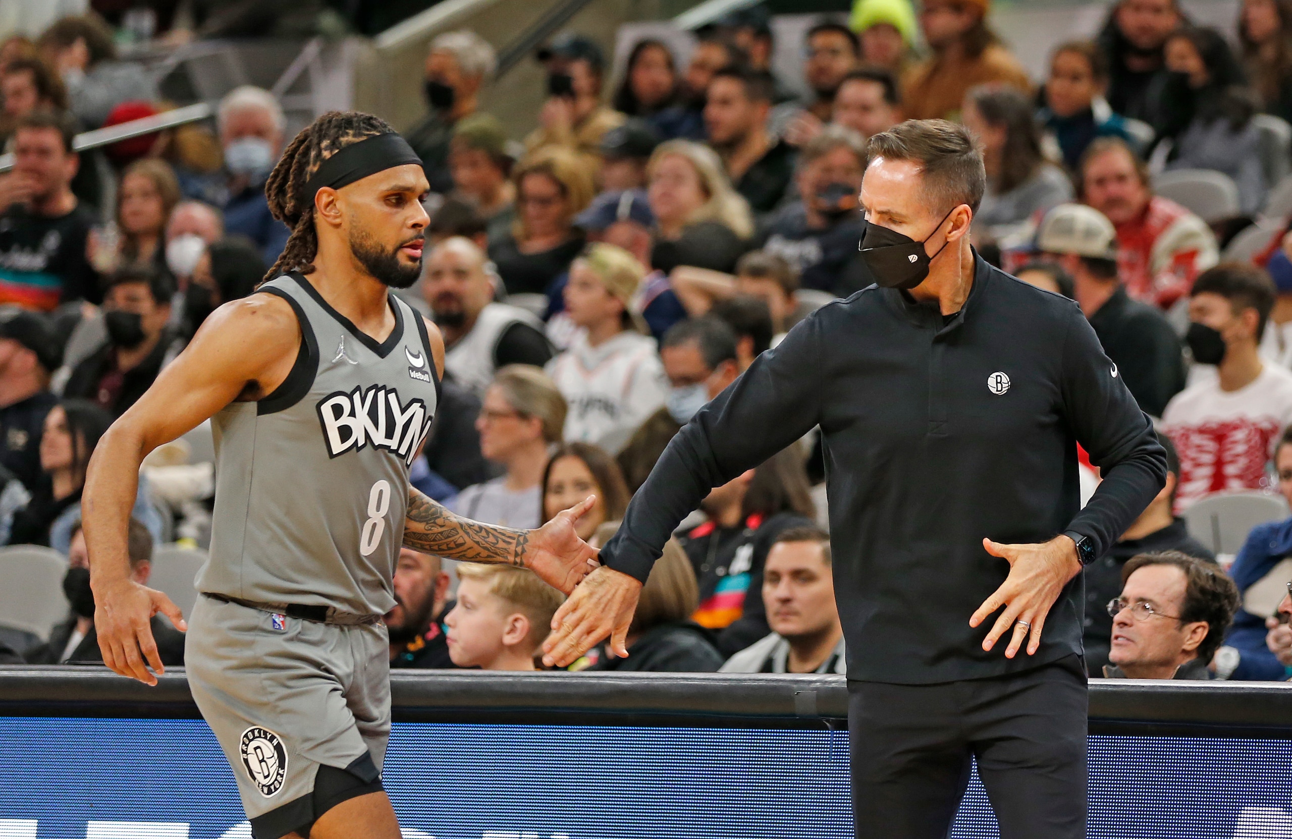 SAN ANTONIO, TX - JANUARY 21: Steve Nash Head coach of the Brooklyn Nets greets Patty Mills #8 of the Brooklyn Nets as he comes to the bench during game against the San Antonio Spurs in the first half at AT&T Center on January 21, 2022 in San Antonio, Texas. NOTE TO USER: User expressly acknowledges and agrees that, by downloading and or using this photograph, User is consenting to terms and conditions of the Getty Images License Agreement. (Photo by Ronald Cortes/Getty Images)