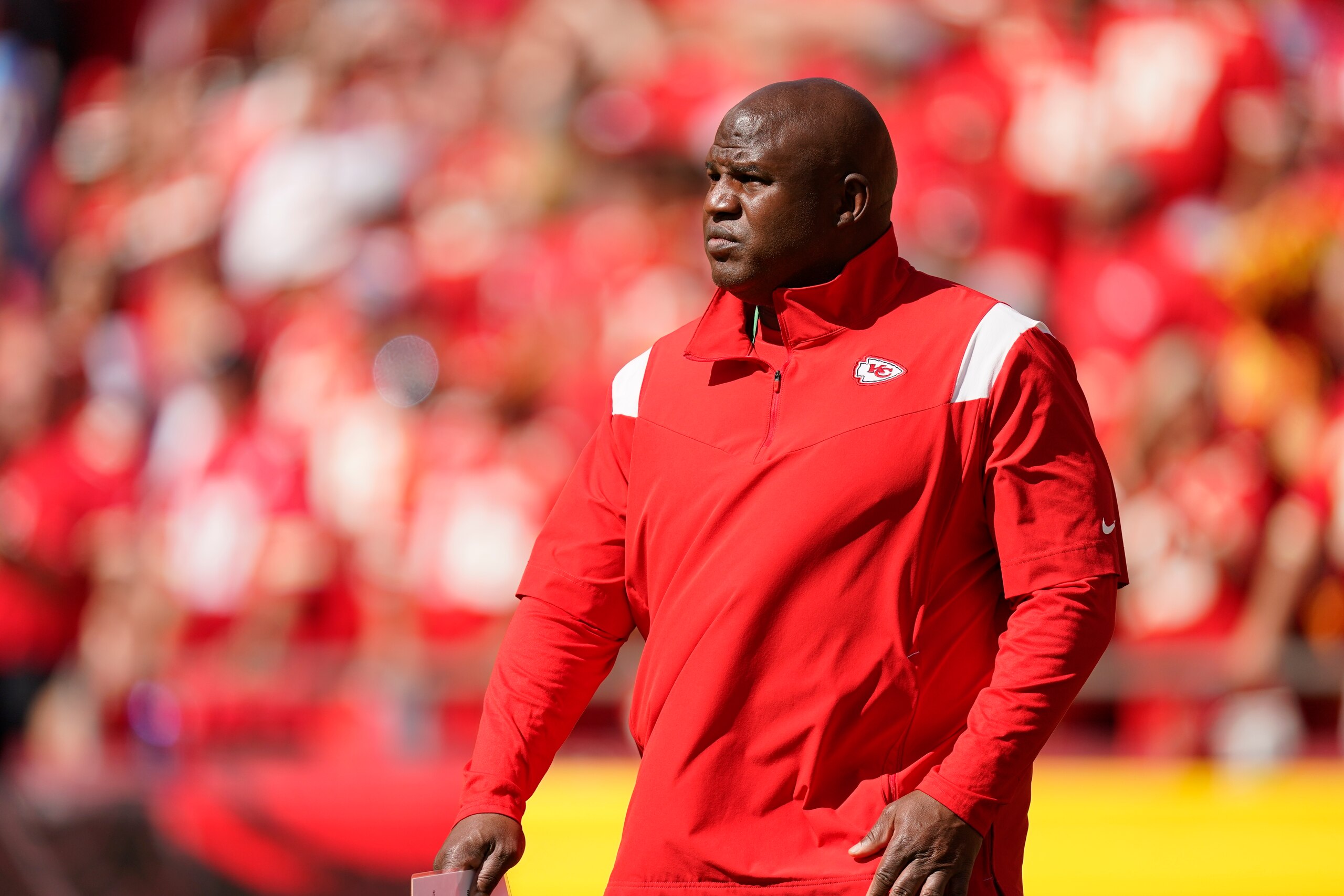 Kansas City Chiefs offensive coordinator Eric Bieniemy watches before an NFL football game between the Kansas City Chiefs and the Los Angeles Chargers, Sunday, Sept. 26, 2021, in Kansas City, Mo. (AP Photo/Charlie Riedel)