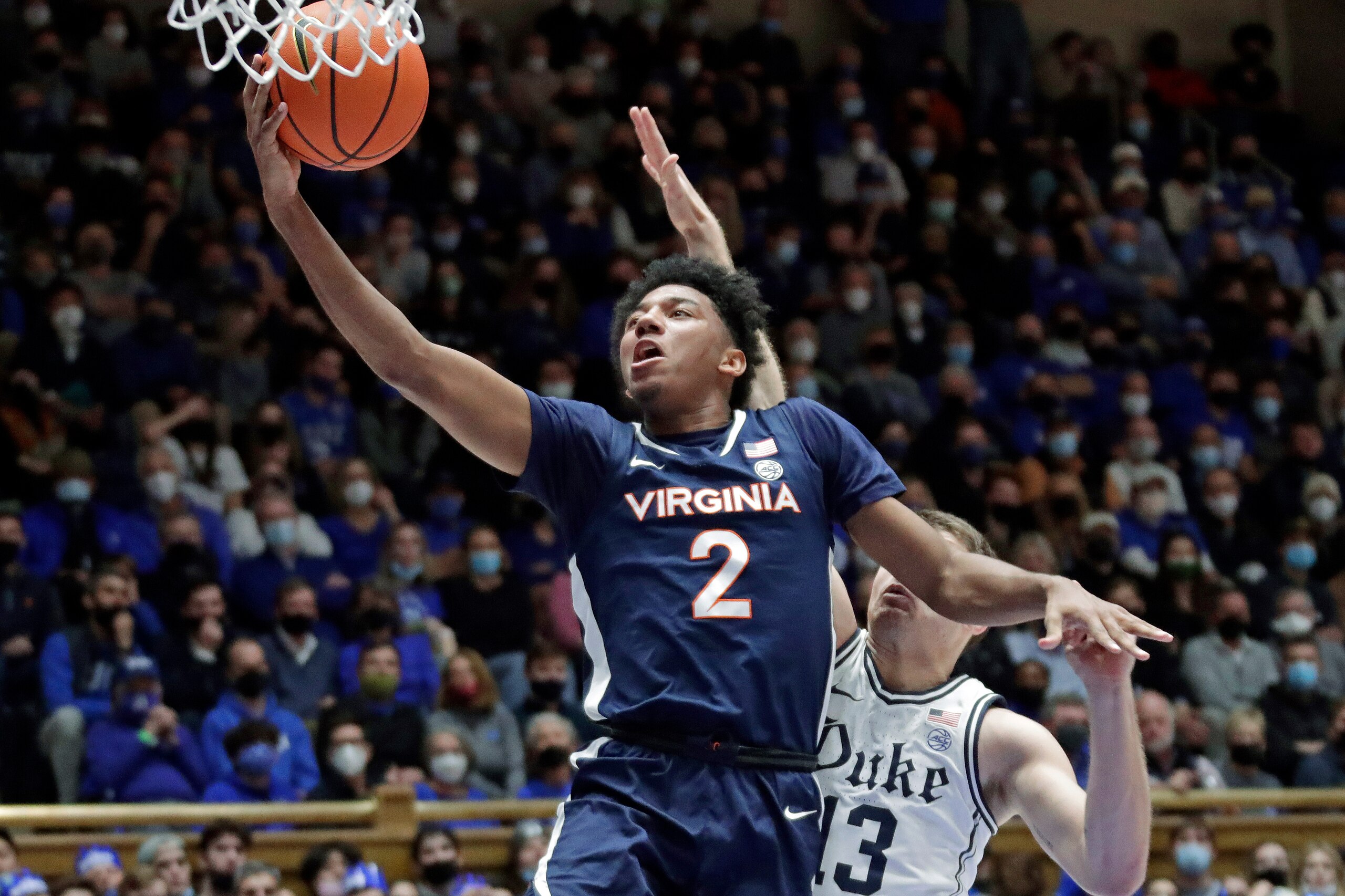 Virginia guard Reece Beekman (2) drives to the hoop past Duke forward Joey Baker (13) during the first half of an NCAA college basketball game, Monday, Feb. 7, 2022, in Durham, N.C. (AP Photo/Chris Seward)