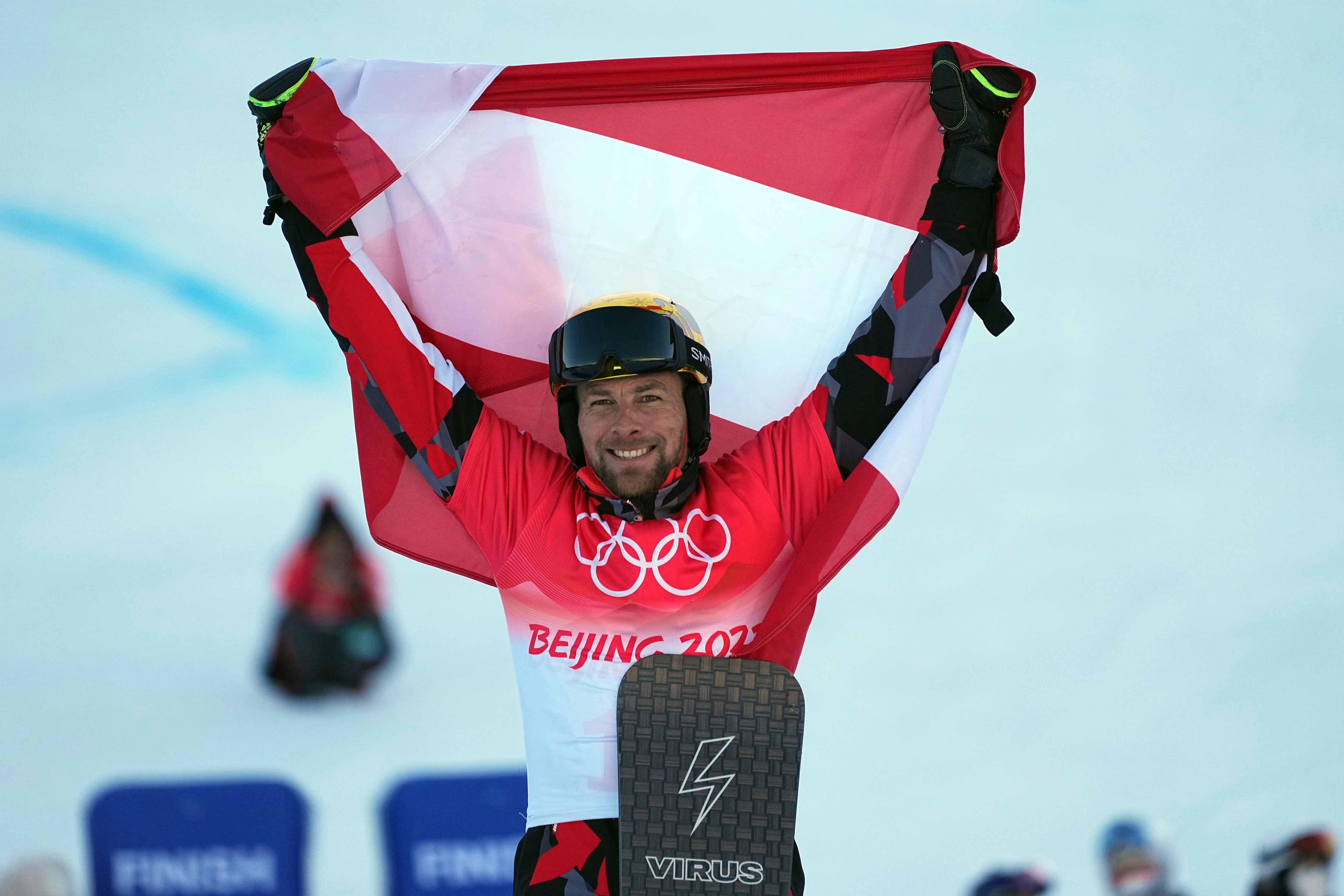 Gold medalist Austria's Benjamin Karl celebrates during the venue ceremony for the men's parallel giant slalom at the 2022 Winter Olympics, Tuesday, Feb. 8, 2022, in Zhangjiakou, China. (AP Photo/Gregory Bull)