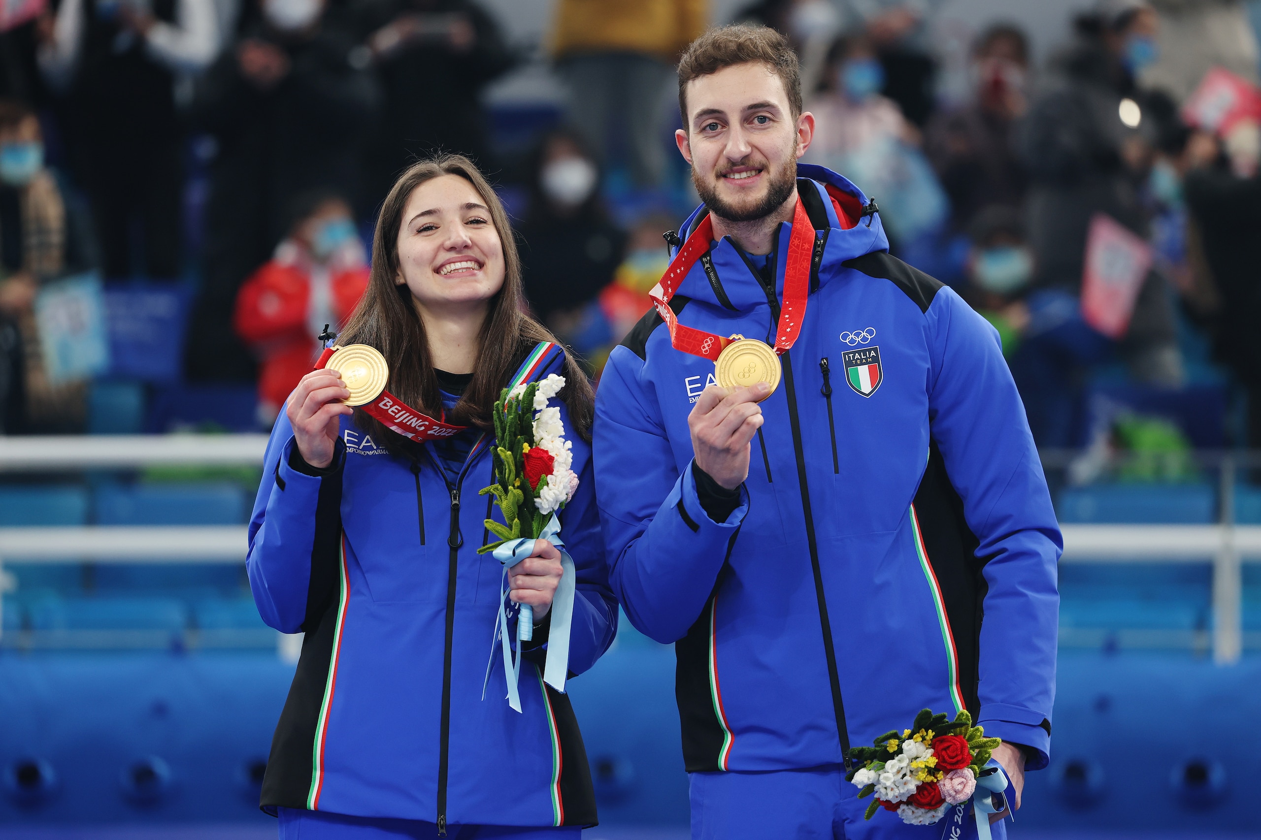 BEIJING, CHINA - FEBRUARY 08: Gold medallists Stefania Constantini and Amos Mosaner of Team Italy pose with their medals during the Curling Mixed Doubles medal ceremony on Day 4 of the Beijing 2022 Winter Olympics at National Aquatics Centre on February 08, 2022 in Beijing, China. (Photo by Lintao Zhang/Getty Images)