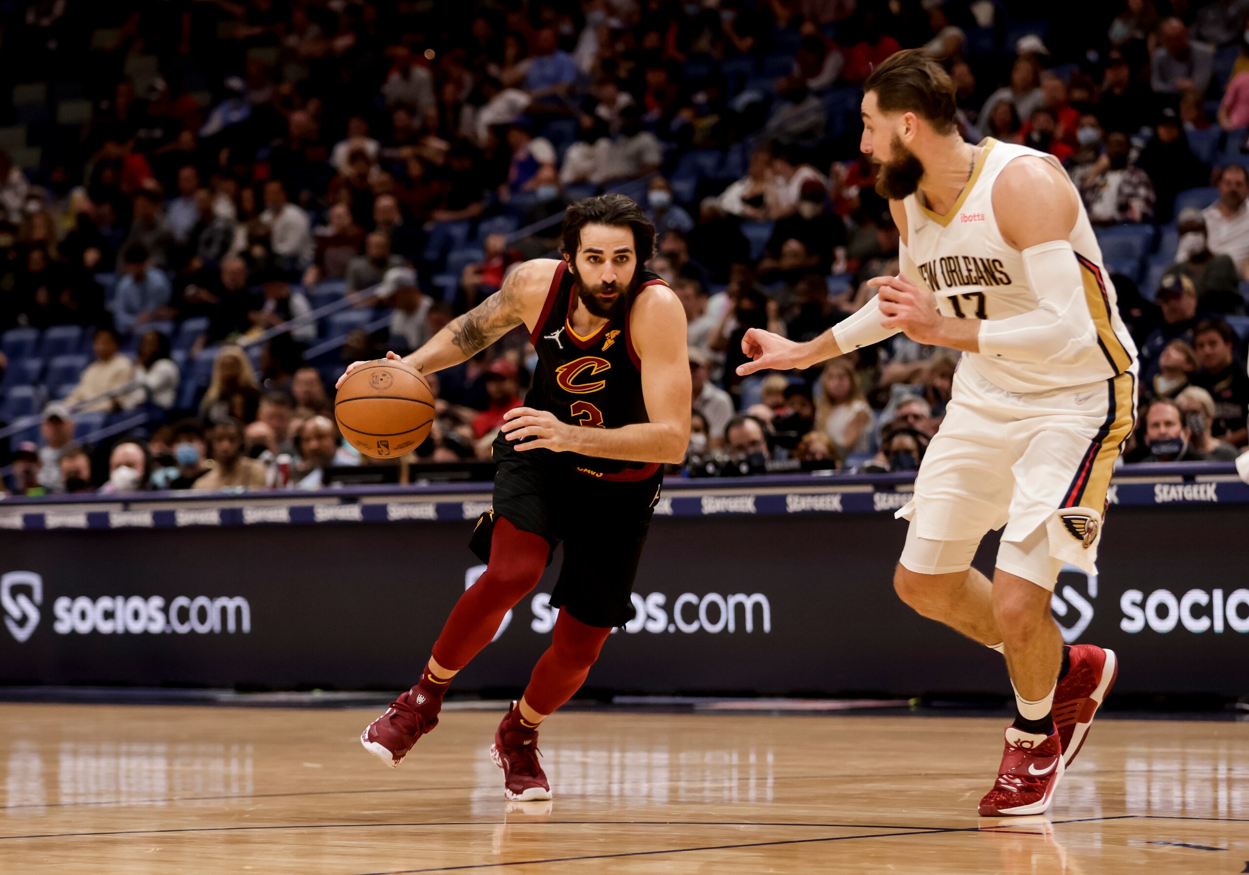 Cleveland Cavaliers guard Ricky Rubio (3) drives past New Orleans Pelicans center Jonas Valanciunas (17) in the second quarter of an NBA basketball game in New Orleans, Tuesday, Dec. 28, 2021. (AP Photo/Derick Hingle)
