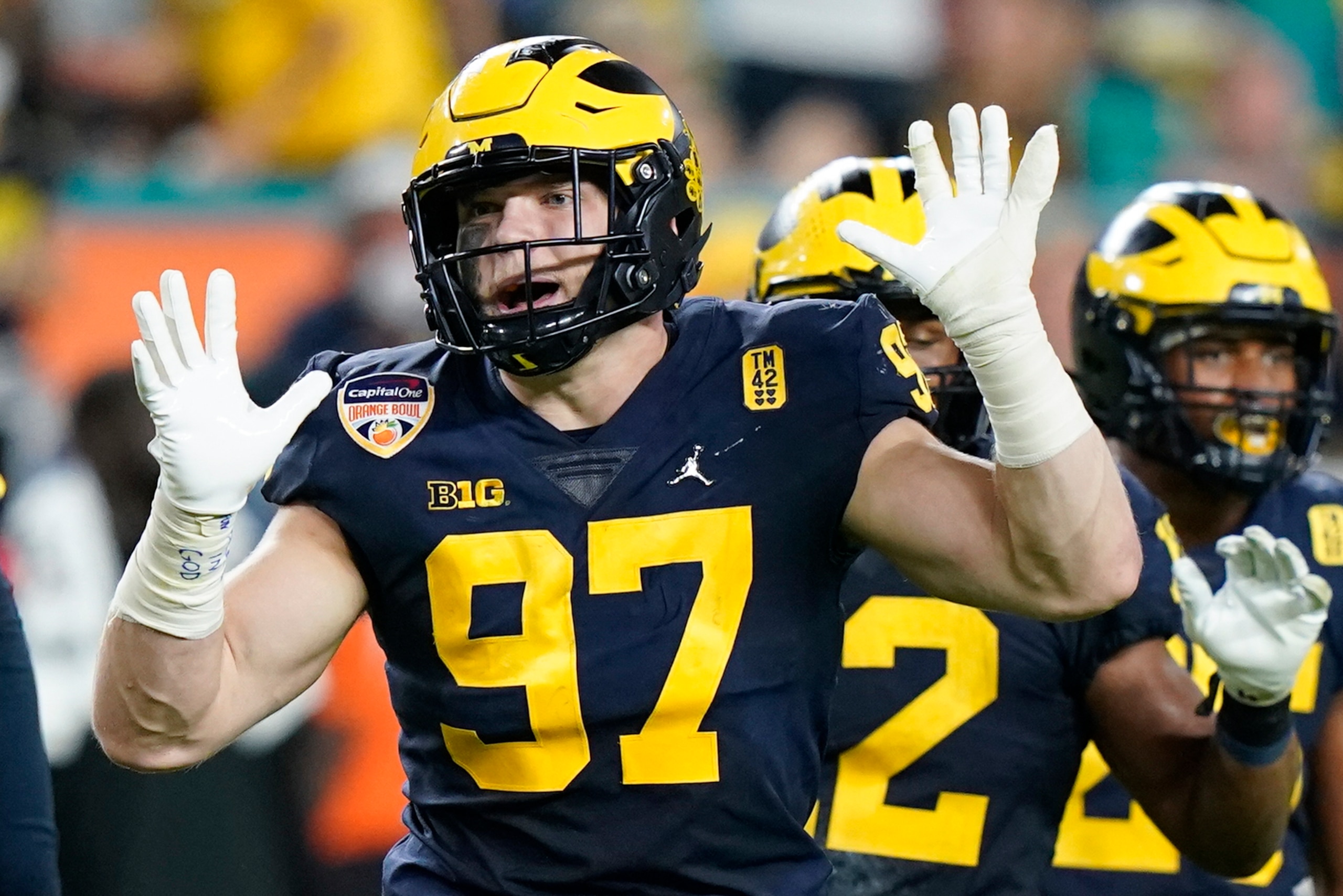 Michigan defensive end Aidan Hutchinson gestures during the first half of the Orange Bowl NCAA College Football Playoff semifinal game against Georgia, Friday, Dec. 31, 2021, in Miami Gardens, Fla. (AP Photo/Lynne Sladky)