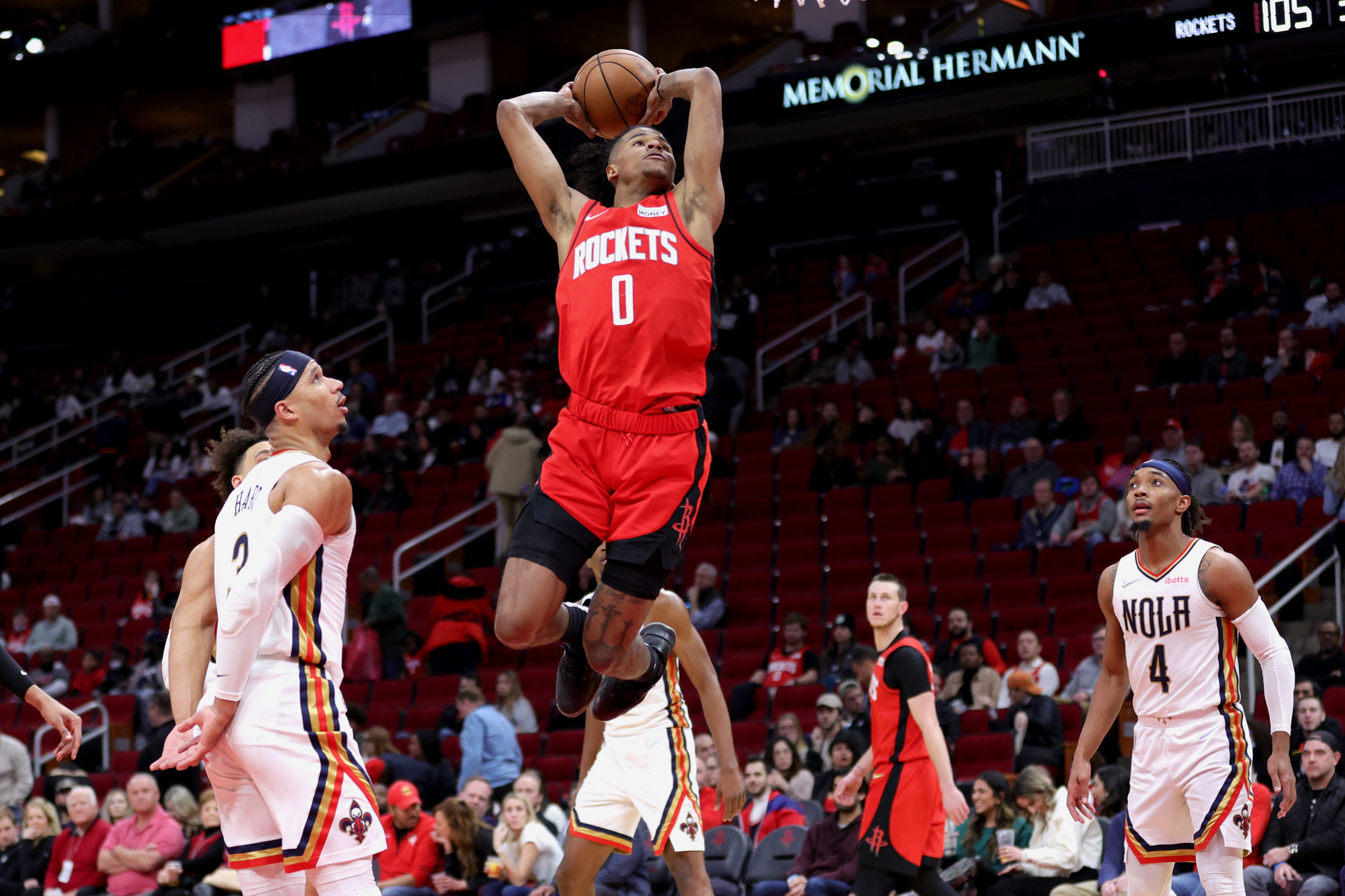 HOUSTON, TEXAS - FEBRUARY 06: Jalen Green #0 of the Houston Rockets dunks the ball ahead of Devonte' Graham #4 of the New Orleans Pelicans during the second half at Toyota Center on February 06, 2022 in Houston, Texas. NOTE TO USER: User expressly acknowledges and agrees that, by downloading and or using this photograph, User is consenting to the terms and conditions of the Getty Images License Agreement. (Photo by Carmen Mandato/Getty Images)