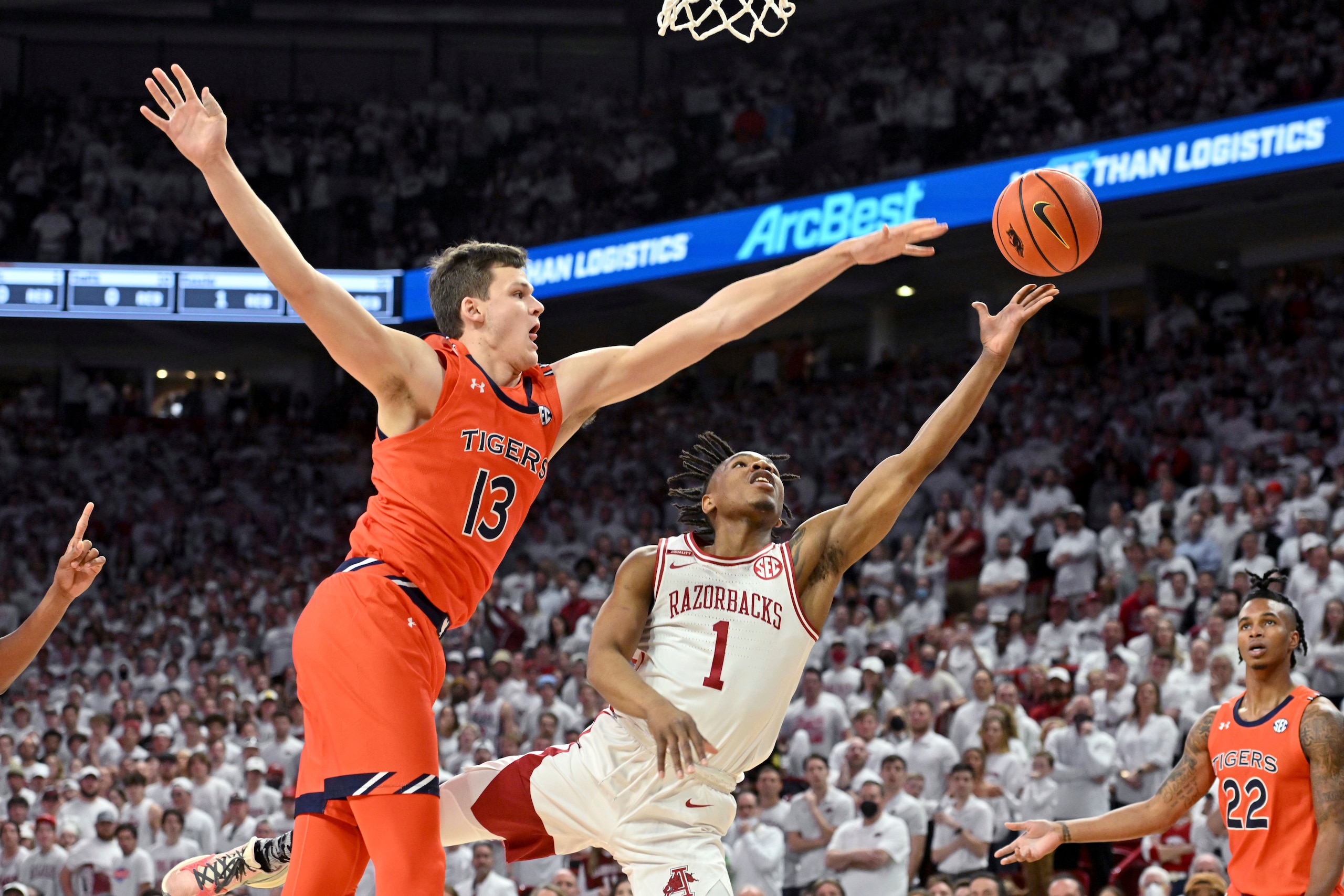 Arkansas guard JD Notae (1) drives past Auburn forward Walker Kessler (13) to score during the first half of an NCAA college basketball game Tuesday, Feb. 8, 2022, in Fayetteville, Ark. (AP Photo/Michael Woods)