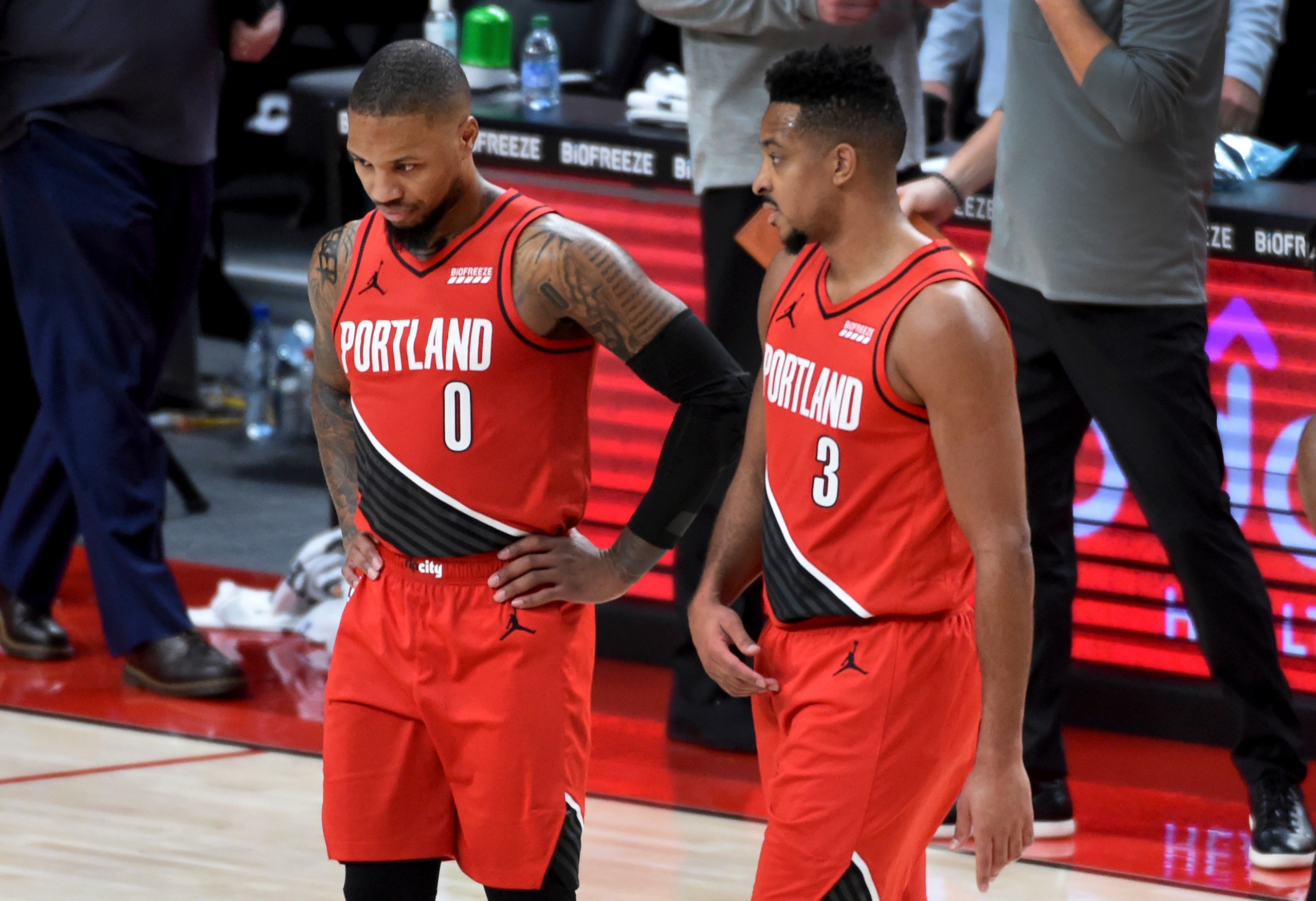 Portland Trail Blazers guard Damian Lillard, left, speaks with guard CJ McCollum, right, during the second half of an NBA basketball game in Portland, Ore., Saturday, Dec. 26, 2020. The Blazers won 128-126 in overtime. (AP Photo/Steve Dykes)