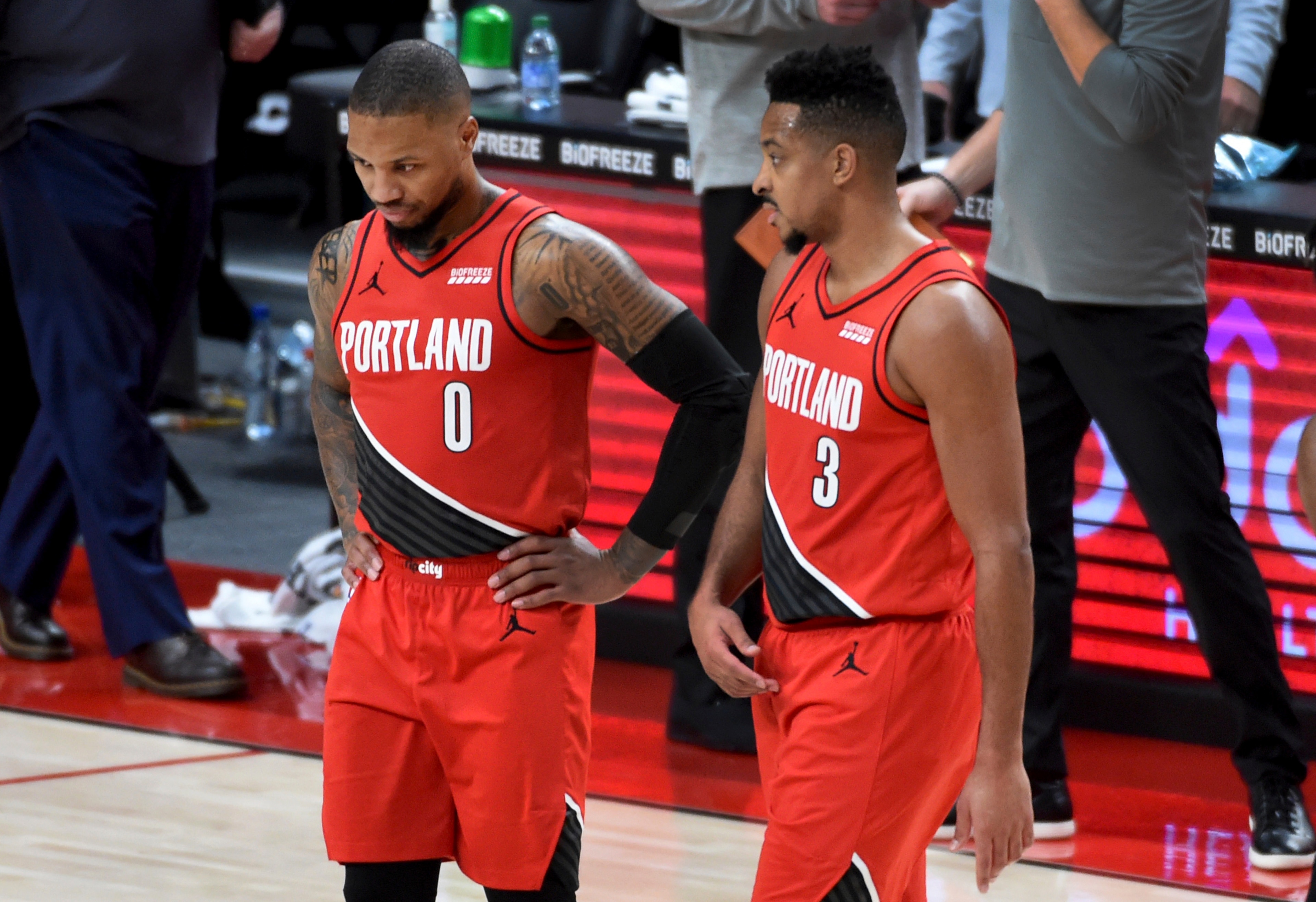 Portland Trail Blazers guard Damian Lillard, left, speaks with guard CJ McCollum, right, during the second half of an NBA basketball game in Portland, Ore., Saturday, Dec. 26, 2020. The Blazers won 128-126 in overtime. (AP Photo/Steve Dykes)