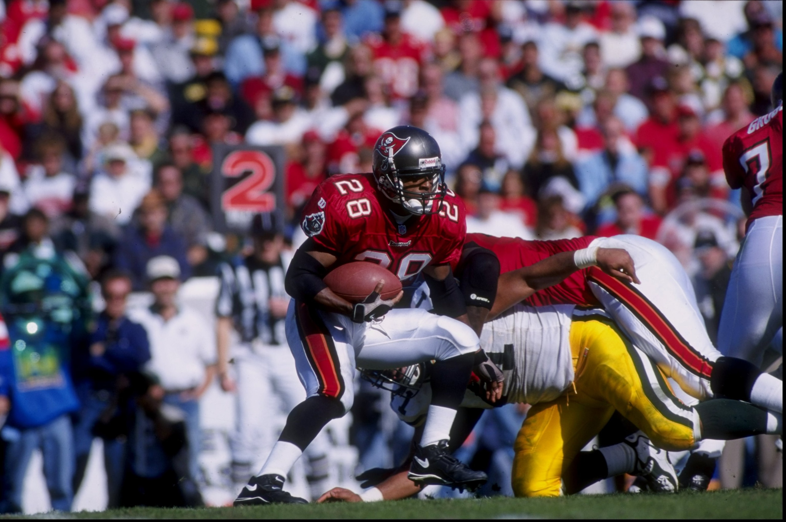 7 Dec 1997:  Running back Warrick Dunn #28 of the Tampa Bay Buccaneers carries the football during the Buccaneers 17-6 loss to the Green Bay Packers at Houlihan''s Stadium in Tampa, Florida. Mandatory Credit: Jamie Squire  /Allsport