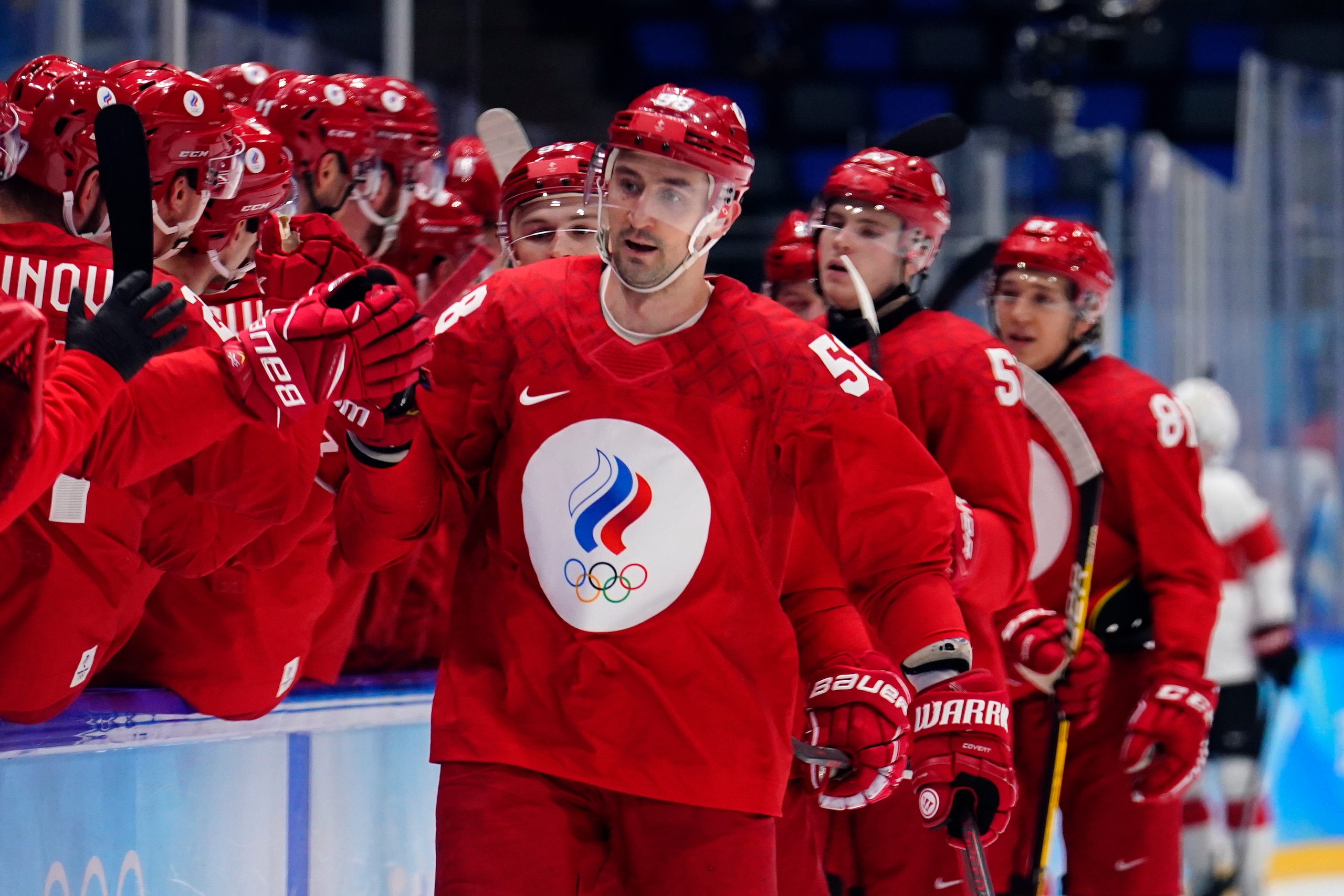 Russian Olympic Committee's Anton Slepyshev (58) is congratulated after scoring a goal against Switzerland during a preliminary round men's hockey game at the 2022 Winter Olympics, Wednesday, Feb. 9, 2022, in Beijing. (AP Photo/Matt Slocum)