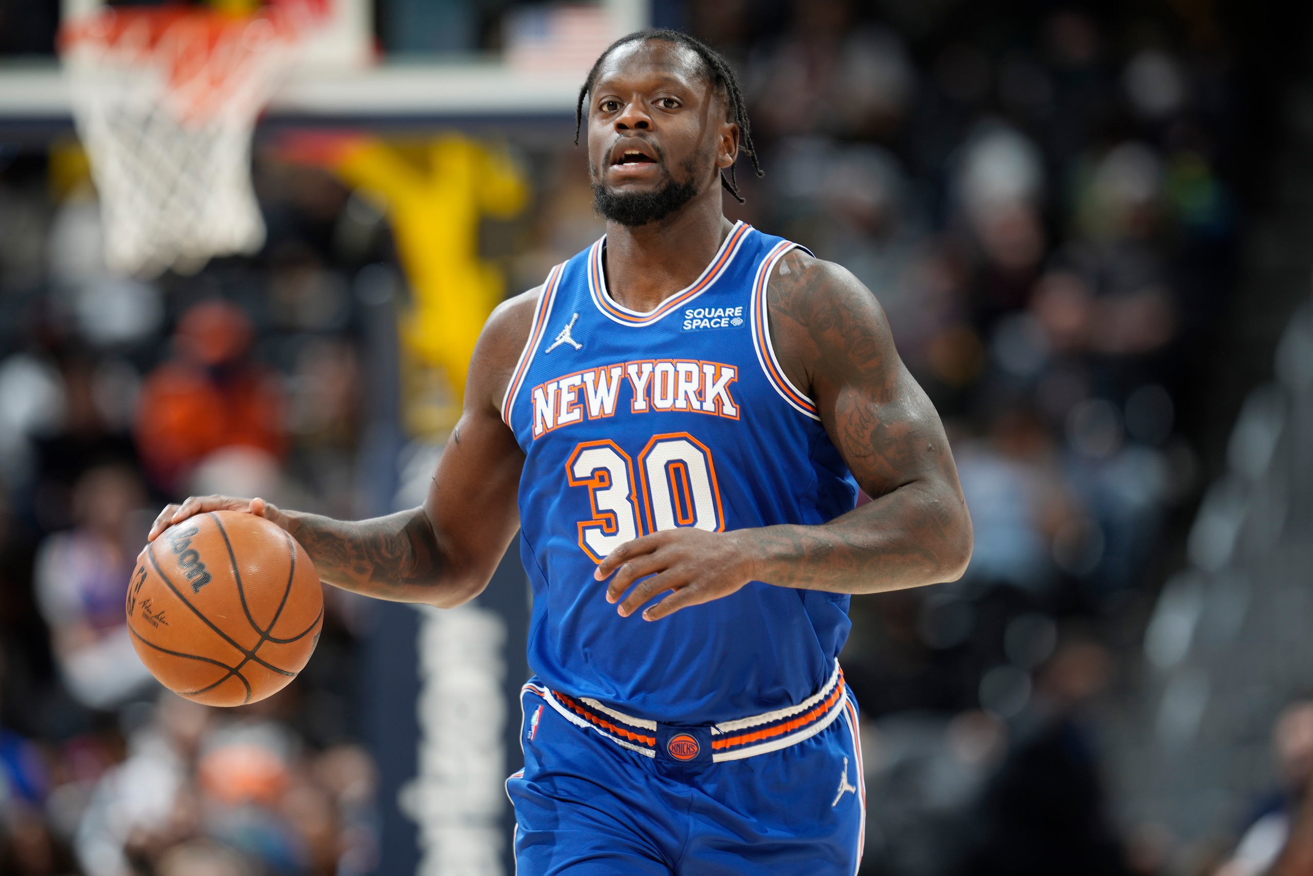 New York Knicks forward Julius Randle brings the ball up during the first half of the team's NBA basketball game against the Denver Nuggets on Tuesday, Feb. 8, 2022, in Denver. (AP Photo/David Zalubowski)