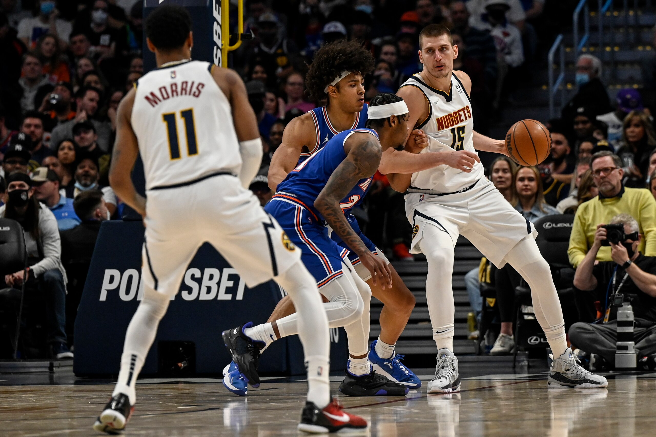 DENVER, CO - FEBRUARY 8: Nikola Jokic (15) of the Denver Nuggets backs down Jericho Sims (45) and Cam Reddish (21) of the New York Knicks during the fourth quarter of Denver"u2019s 132-115 win at Ball Arena on Tuesday, February 8, 2022. (Photo by AAron Ontiveroz/MediaNews Group/The Denver Post via Getty Images)"n