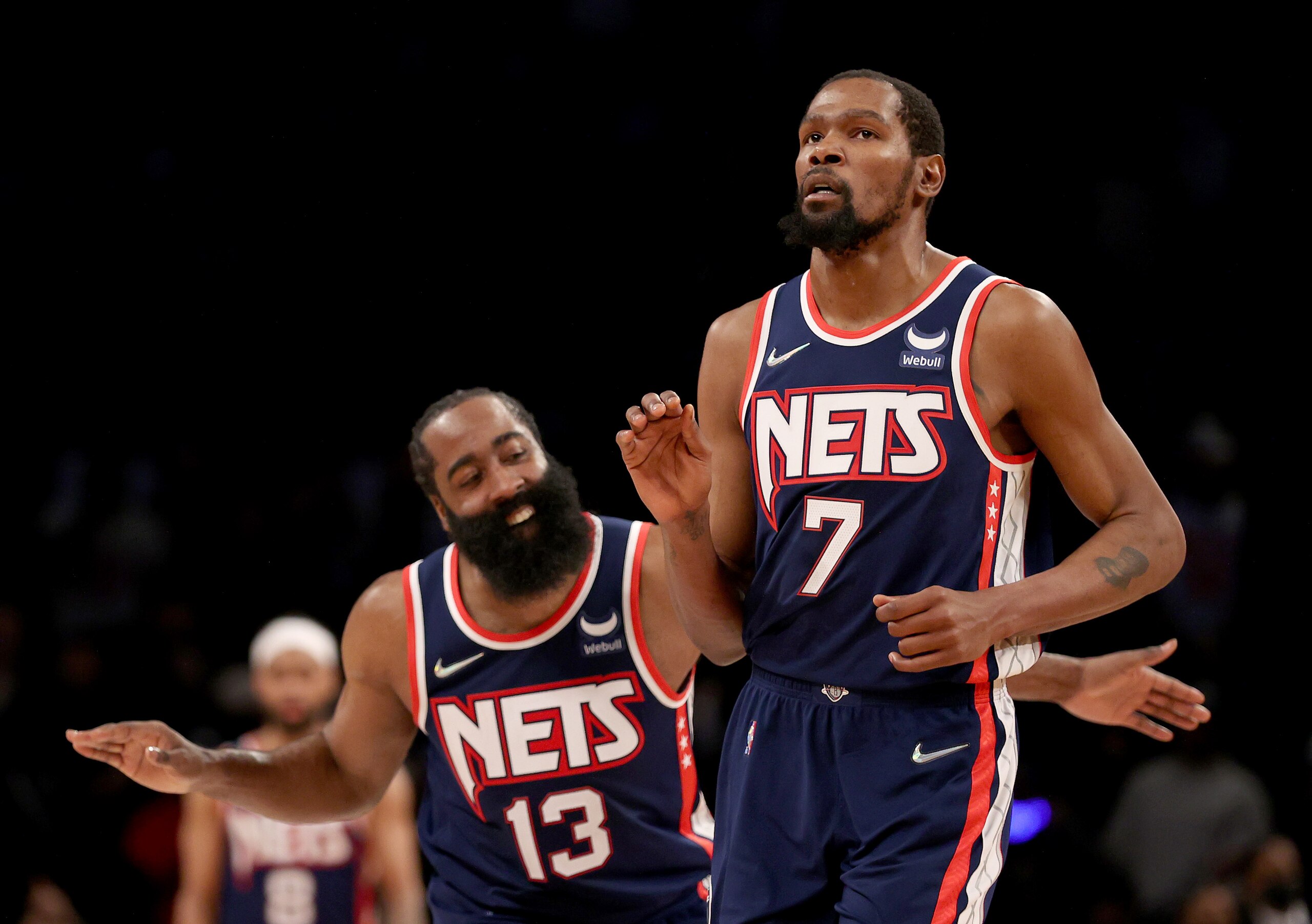 NEW YORK, NEW YORK - DECEMBER 03:  James Harden #13 of the Brooklyn Nets congratulates teammate Kevin Durant #7 after Durant hit a shot to secure the lead in the final minute of the game against the Minnesota Timberwolves at Barclays Center on December 03, 2021 in the Brooklyn borough of New York City. The Brooklyn Nets defeated the Minnesota Timberwolves 110-105. NOTE TO USER: User expressly acknowledges and agrees that, by downloading and or using this photograph, User is consenting to the terms and conditions of the Getty Images License Agreement. (Photo by Elsa/Getty Images)