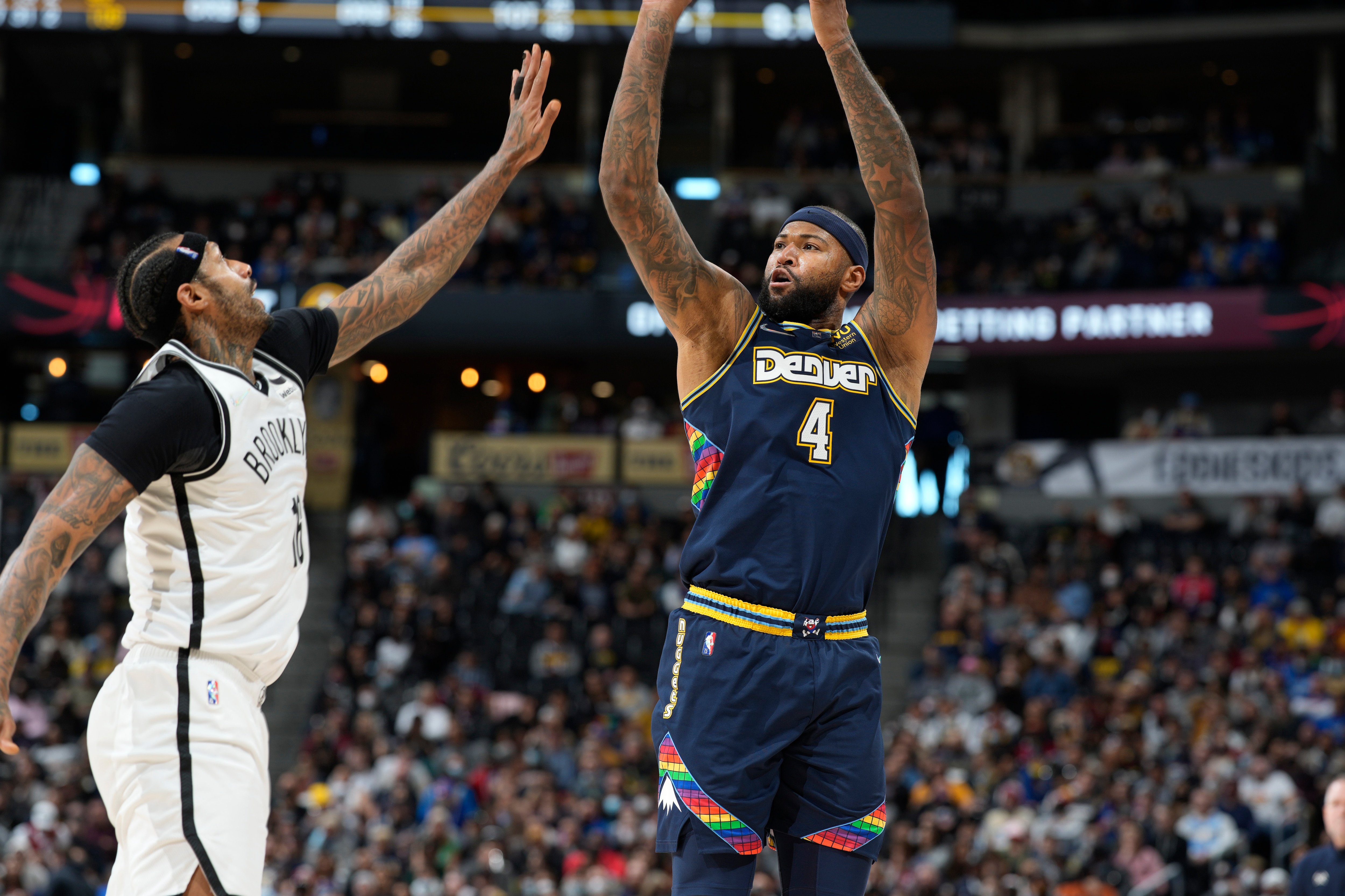 Brooklyn Nets forward James Johnson (16) and Denver Nuggets center DeMarcus Cousins (4) in the second half of an NBA basketball game Sunday, Feb. 6, 2022, in Denver. The Nuggets won 124-104. (AP Photo/David Zalubowski)
