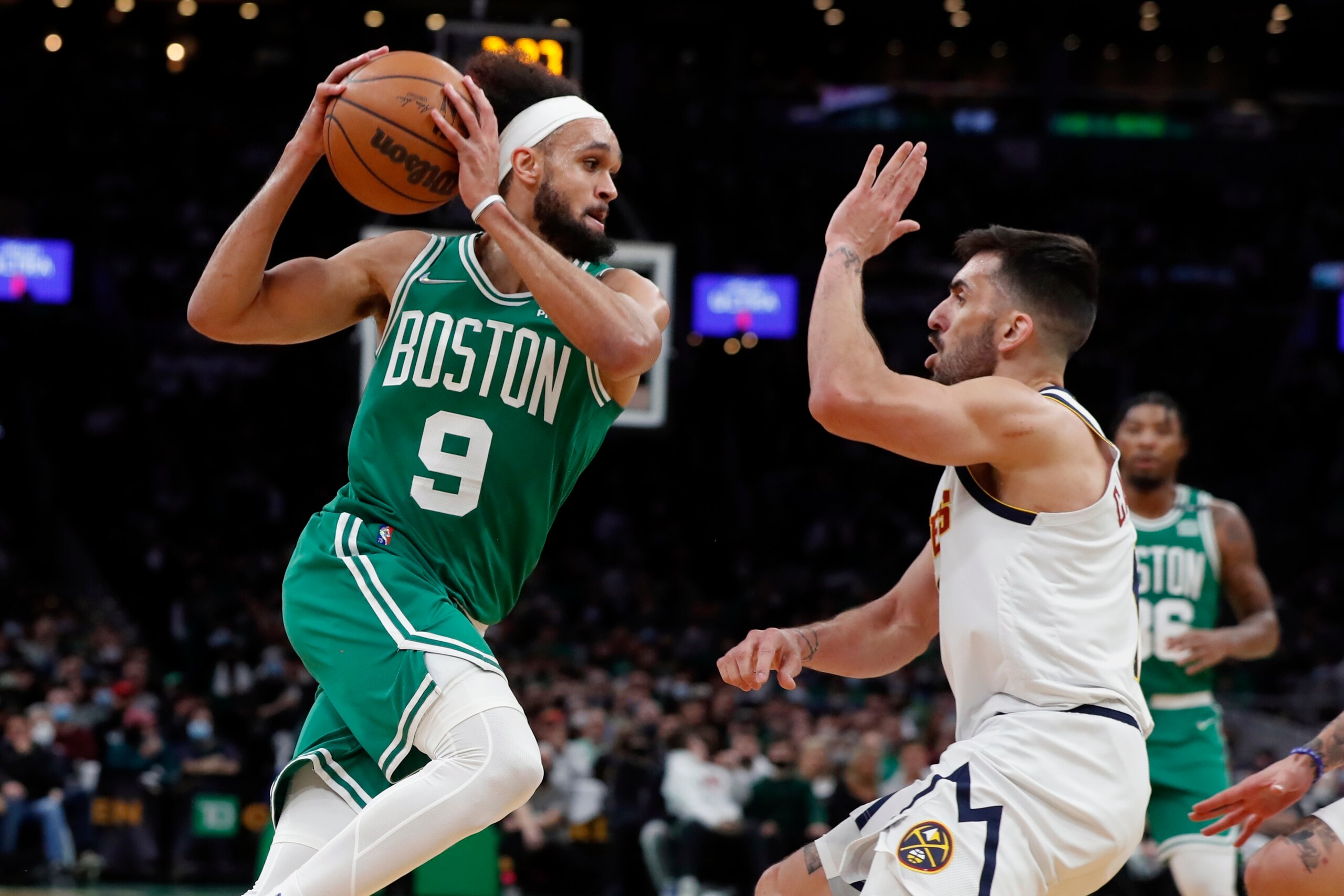 Boston Celtics' Derrick White (9) drives against Denver Nuggets' Facundo Campazzo during the first half of an NBA basketball game Friday, Feb. 11, 2022, in Boston. (AP Photo/Michael Dwyer) Boston Celtics' Derrick White (9) drives against Denver Nuggets' Facundo Campazzo during the first half of an NBA basketball game Friday, Feb. 11, 2022, in Boston. (AP Photo/Michael Dwyer)