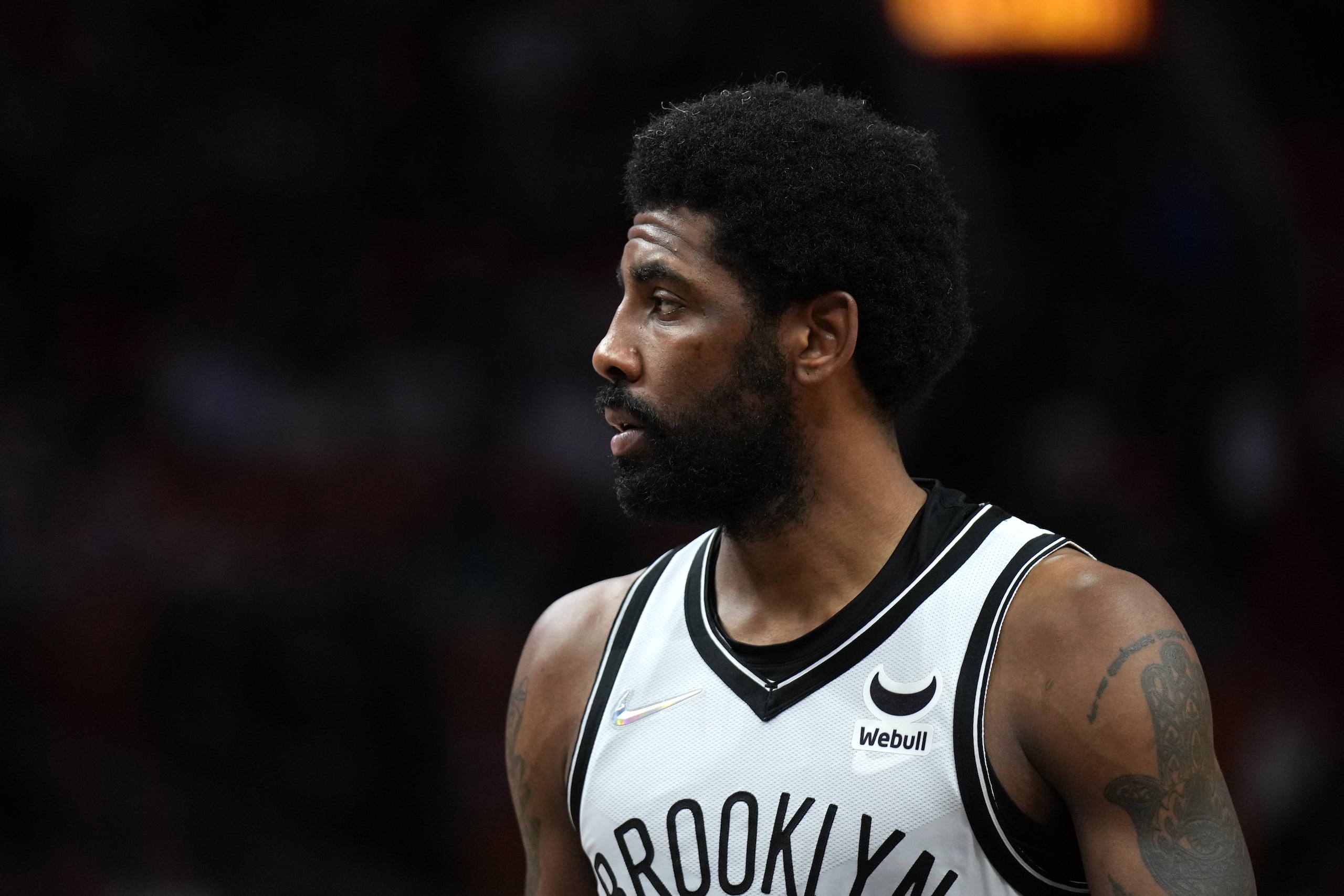MIAMI, FL - FEBRUARY 12:  Kyrie Irving #11 of the Brooklyn Nets looks on during the game against the Miami Heat on February 12, 2022 at FTX Arena in Miami, Florida. NOTE TO USER: User expressly acknowledges and agrees that, by downloading and or using this Photograph, user is consenting to the terms and conditions of the Getty Images License Agreement. Mandatory Copyright Notice: Copyright 2022 NBAE (Photo by Joseph Guzy/NBAE via Getty Images)