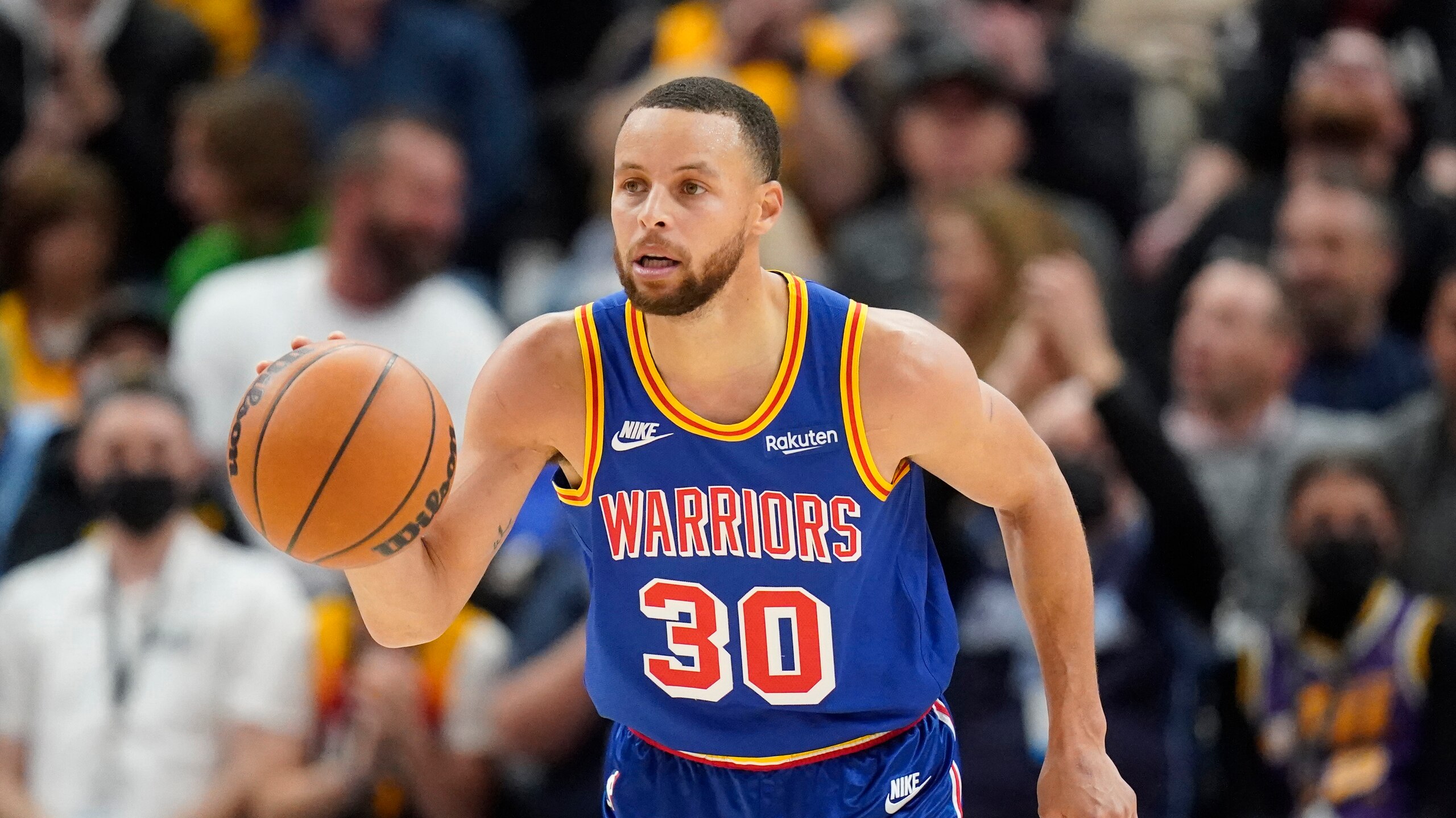 Golden State Warriors guard Stephen Curry (30) brings the ball up court in the first half during an NBA basketball game against the Utah Jazz Wednesday, Feb. 9, 2022, in Salt Lake City. (AP Photo/Rick Bowmer)