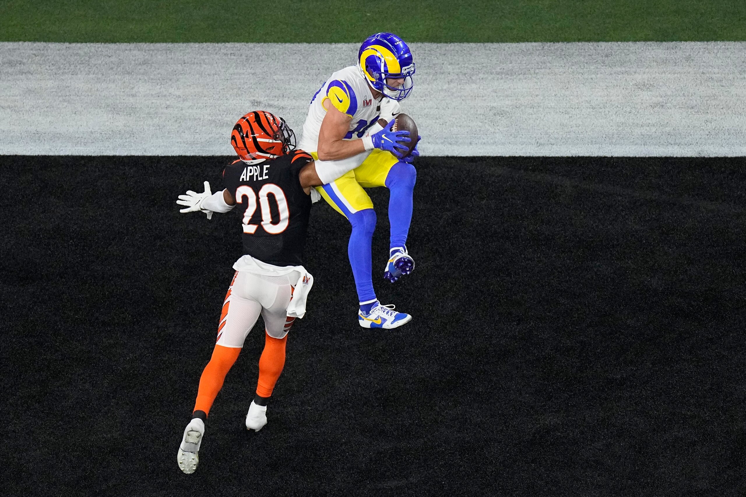 Los Angeles Rams wide receiver Cooper Kupp (10) grabs a touchdown pass as Cincinnati Bengals cornerback Eli Apple (20) makes the tackle during the second half of the NFL Super Bowl 56 football game, Sunday, Feb. 13, 2022, in Inglewood, Calif. (AP Photo/Matt Rourke)