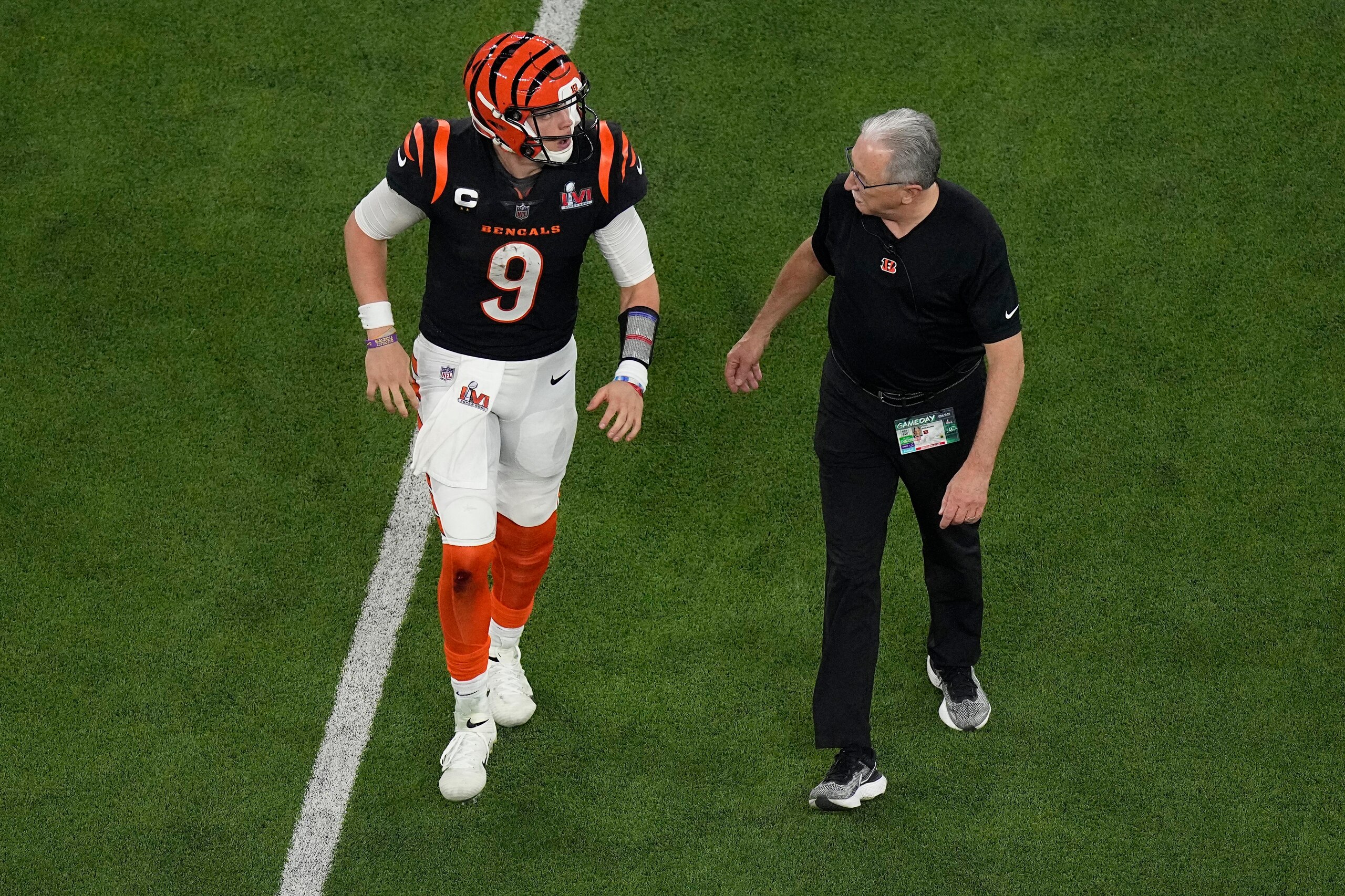 Cincinnati Bengals quarterback Joe Burrow (9) is assisted off the field during the second half of the NFL Super Bowl 56 football game against the Los Angeles Rams, Sunday, Feb. 13, 2022, in Inglewood, Calif. (AP Photo/Matt Rourke)