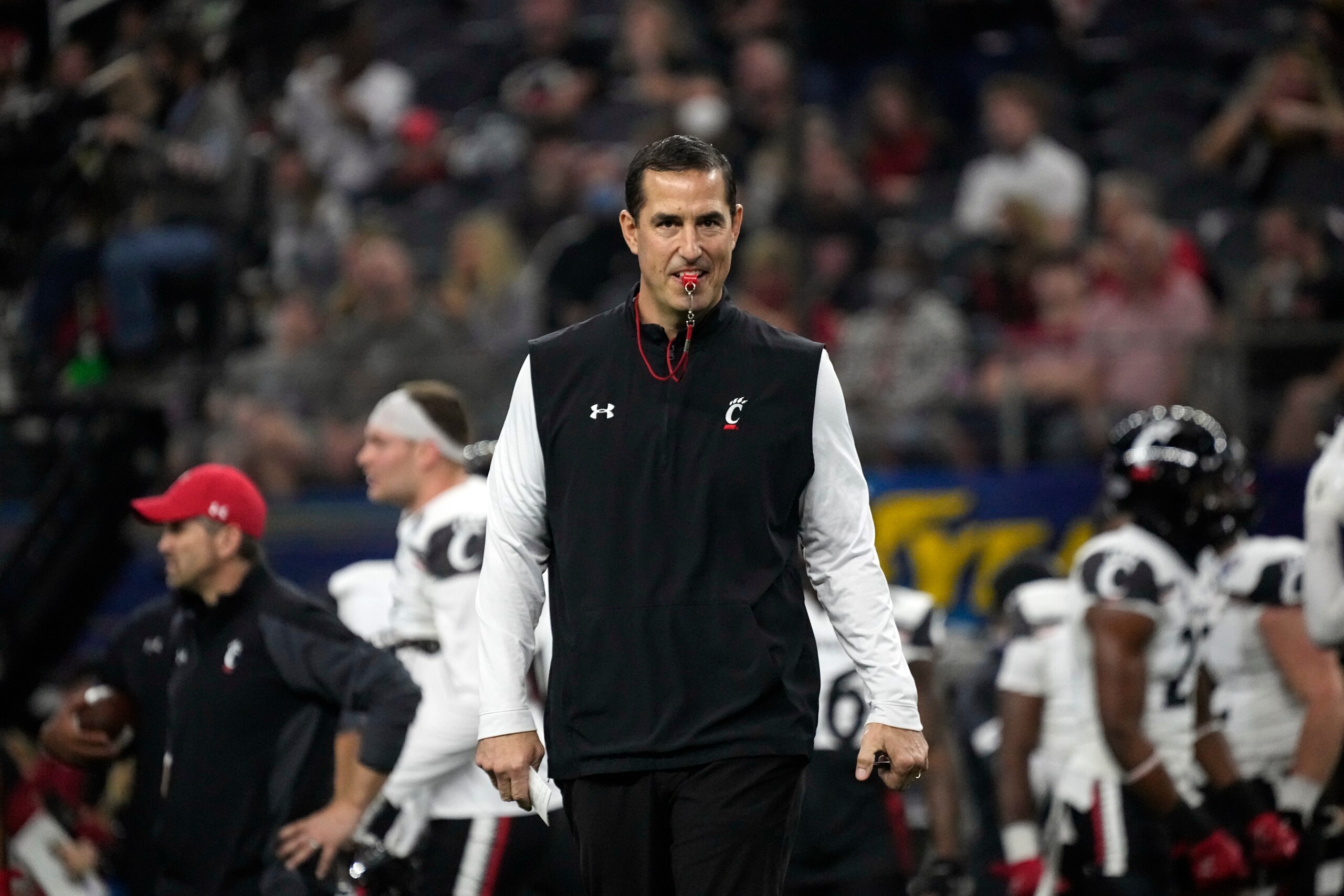 Cincinnati coach Luke Fickell watches his team warm up before the Cotton Bowl NCAA College Football Playoff semifinal game against Alabama, Friday, Dec. 31, 2021, in Arlington, Texas. (AP Photo/Jeffrey McWhorter)