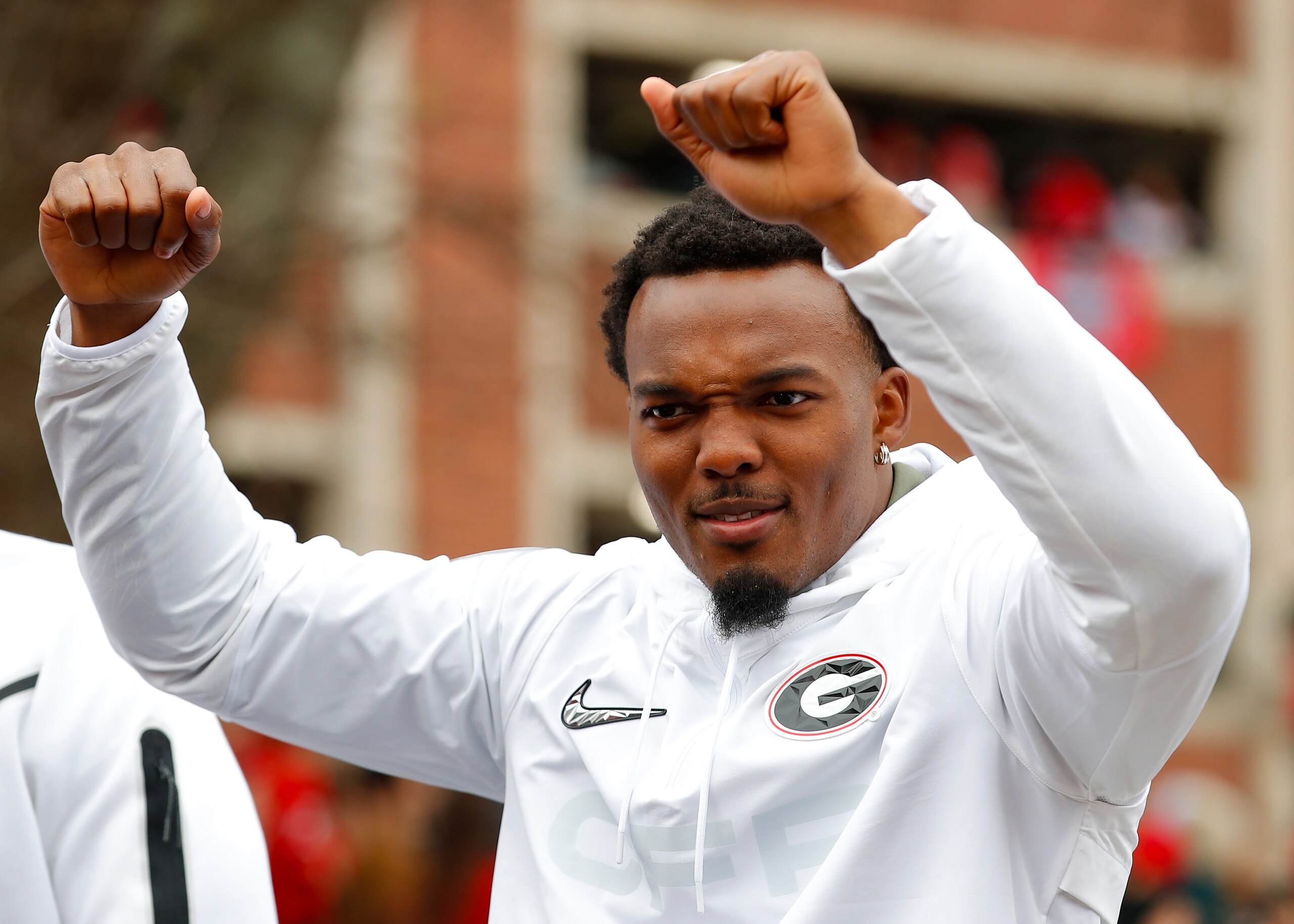ATHENS, GA - JANUARY 15: Nakobe Dean #17 of the Georgia Bulldogs rides along during the parade honoring the Georgia Bulldogs national championship victory on January 15, 2022 in Athens, Georgia. (Photo by Todd Kirkland/Getty Images)