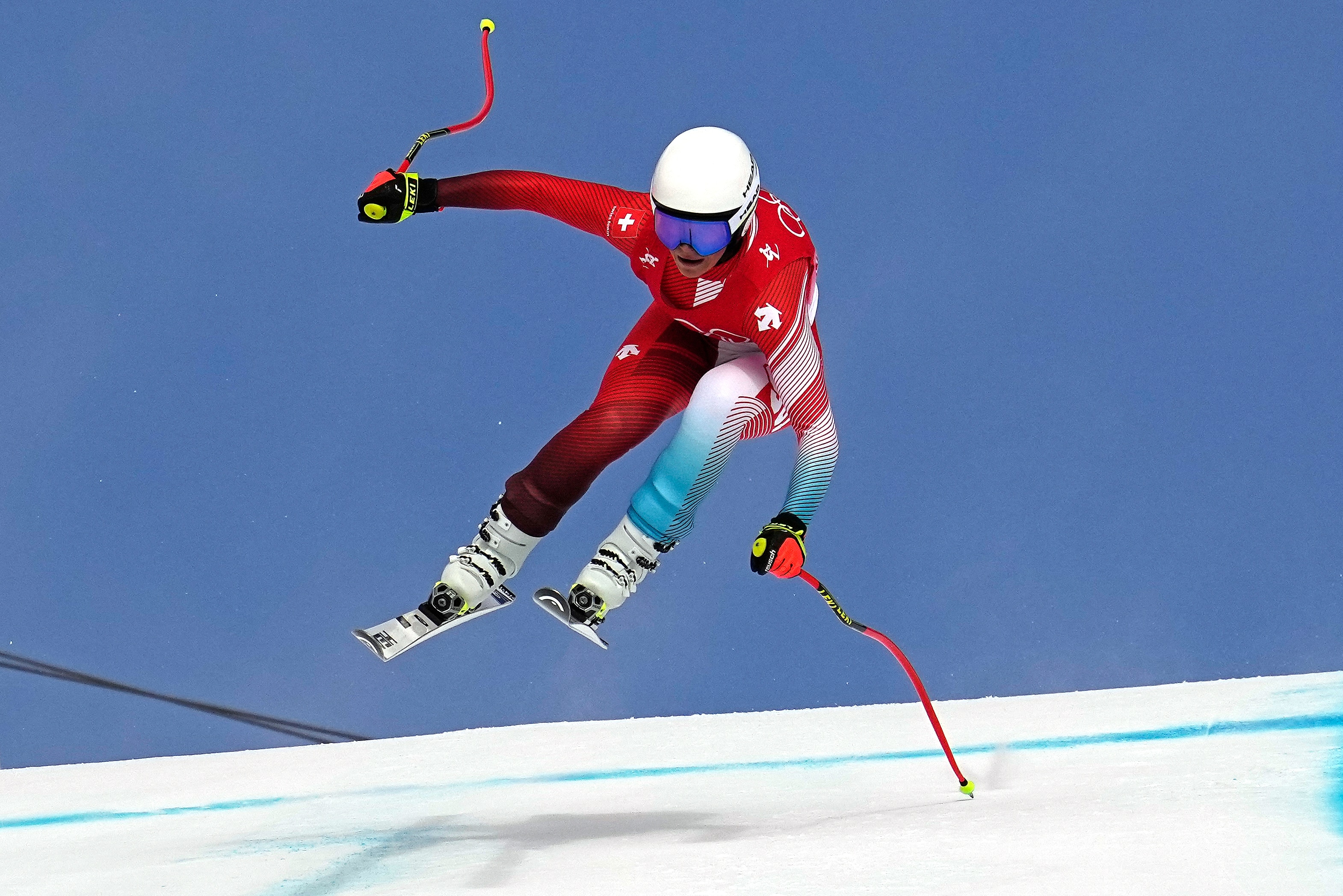 Corinne Suter, of Switzerland makes a jump during the women's downhill at the 2022 Winter Olympics, Tuesday, Feb. 15, 2022, in the Yanqing district of Beijing. (AP Photo/Robert F. Bukaty)