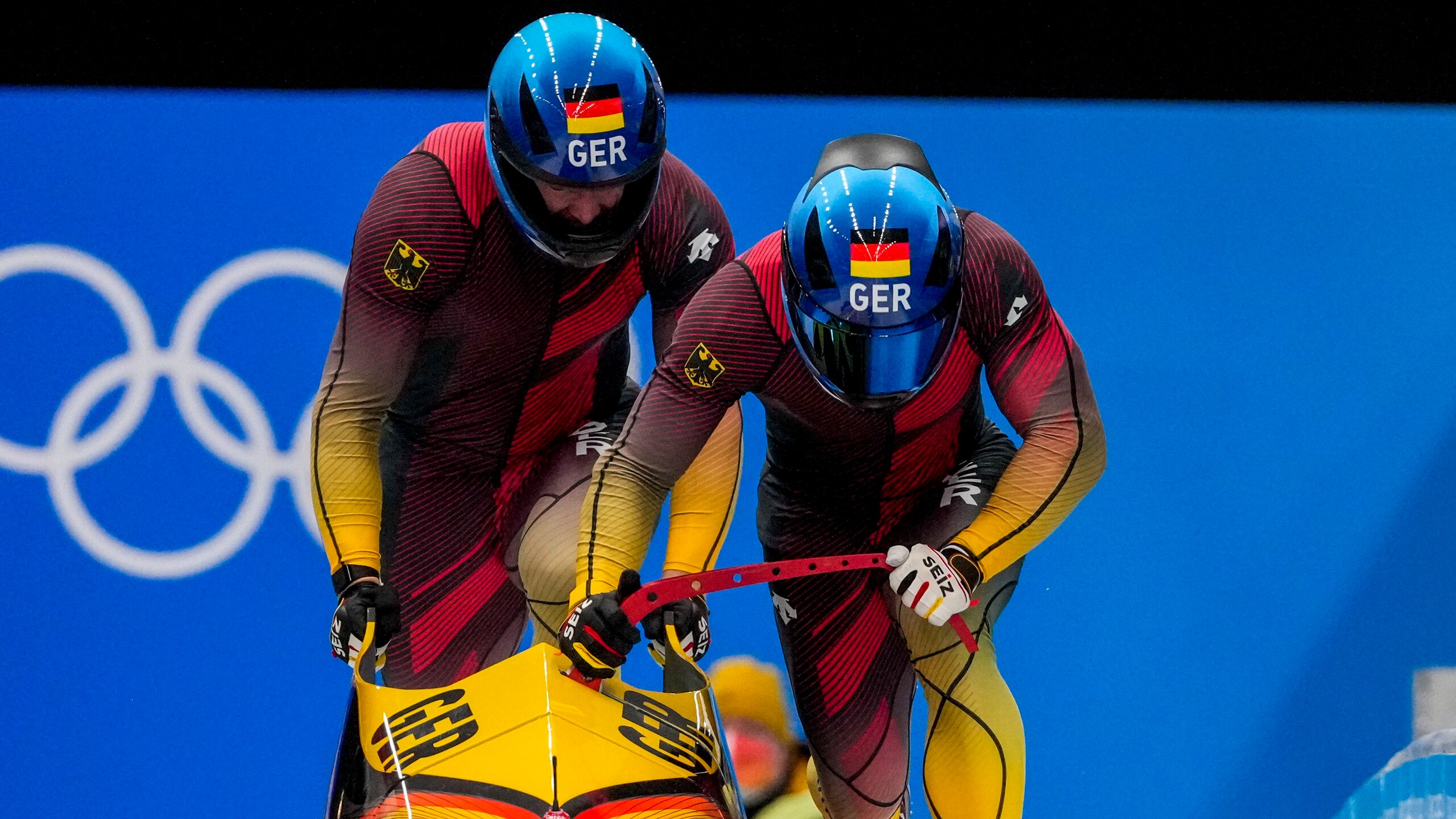 Francesco Friedrich and Thorsten Margis, of Germany, start the 2-man heat 3 at the 2022 Winter Olympics, Tuesday, Feb. 15, 2022, in the Yanqing district of Beijing. (AP Photo/Dmitri Lovetsky)