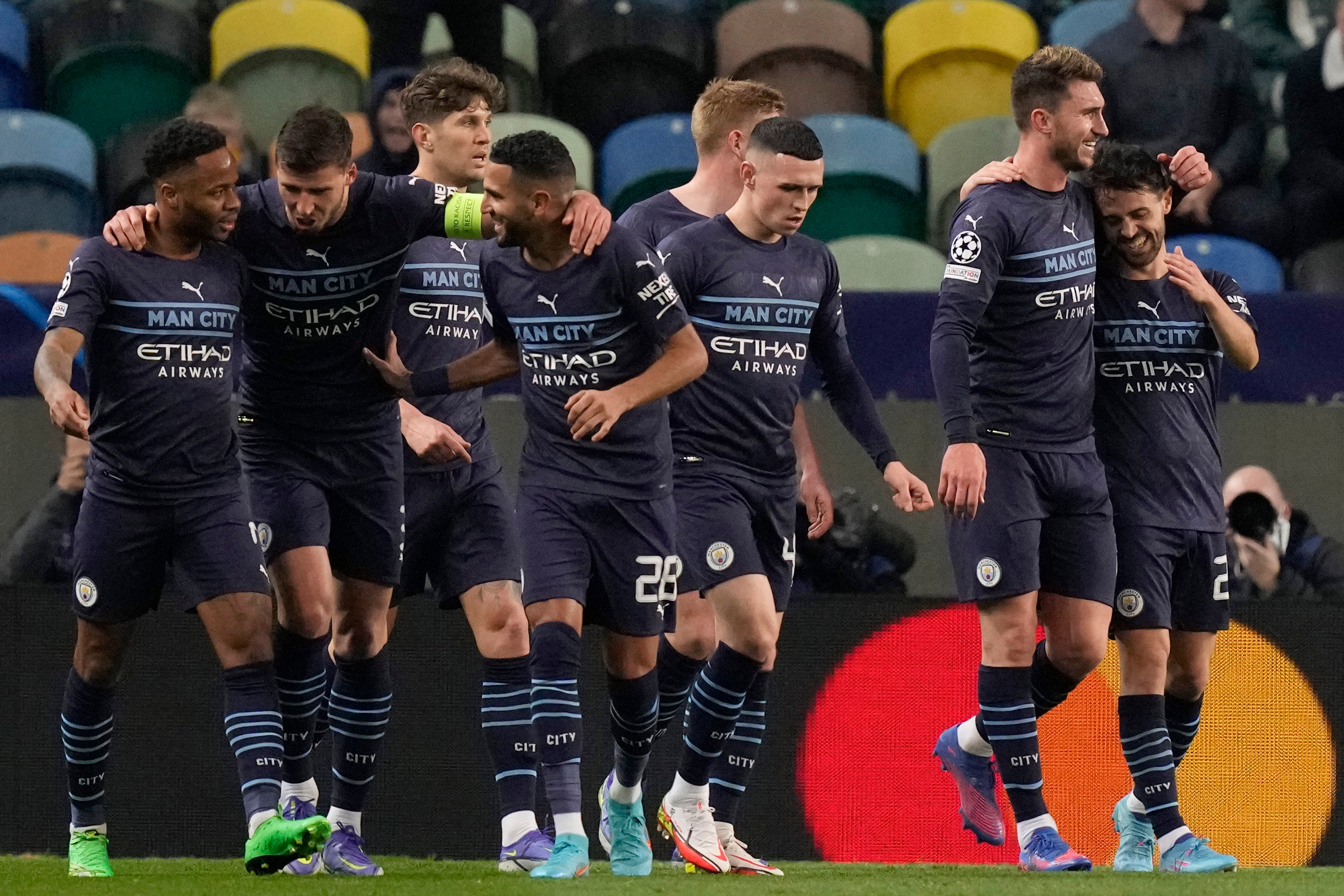 Manchester City players celebrate the second goal of their team during the Champions League round of 16 soccer match between Sporting CP and Manchester City at the Alvalade stadium in Lisbon, Portugal, Tuesday, Feb. 15, 2022. (AP Photo/Armando Franca)